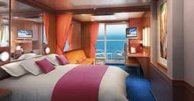 Norwegian Jade cruise ship Mini Suite with two beds, sitting area, and private b