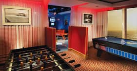 Norwegian Star cruise ship Teen Club with a video wall, jukebox, and air hockey.
