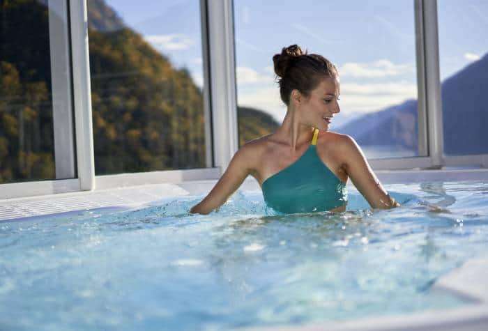 Woman enjoying her solo cruise in the hot tub onboard Norwegian Bliss cruise ship