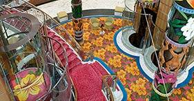 Norwegian Sky cruise ship Atrium with the Mani Reception Desk and Shore Excursio
