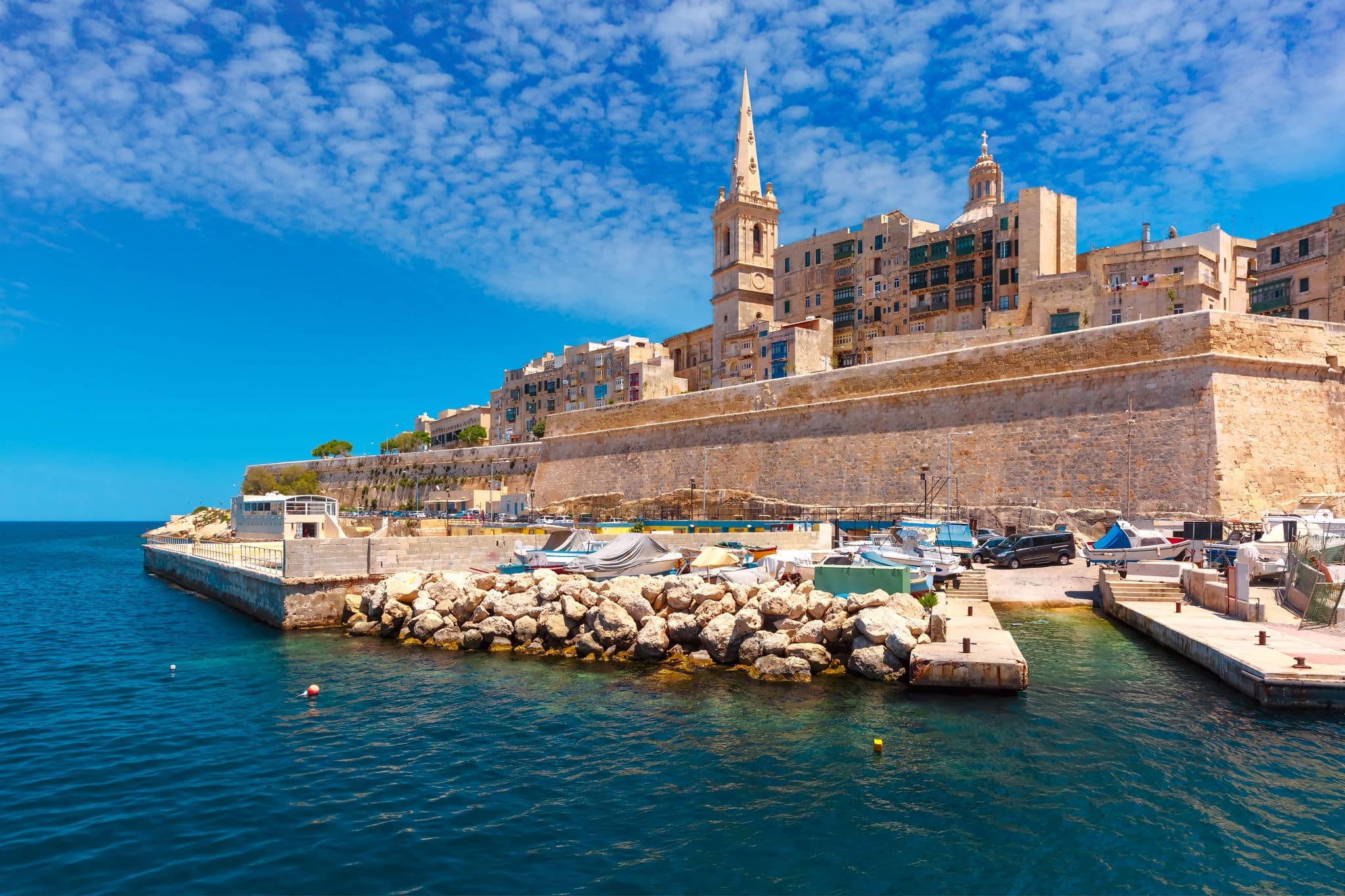 Valletta Skyline with fortress wall, boat pier and St. Paul's Anglican Pro-Cathedral, Valletta, Capital city of Malta. View from the sea