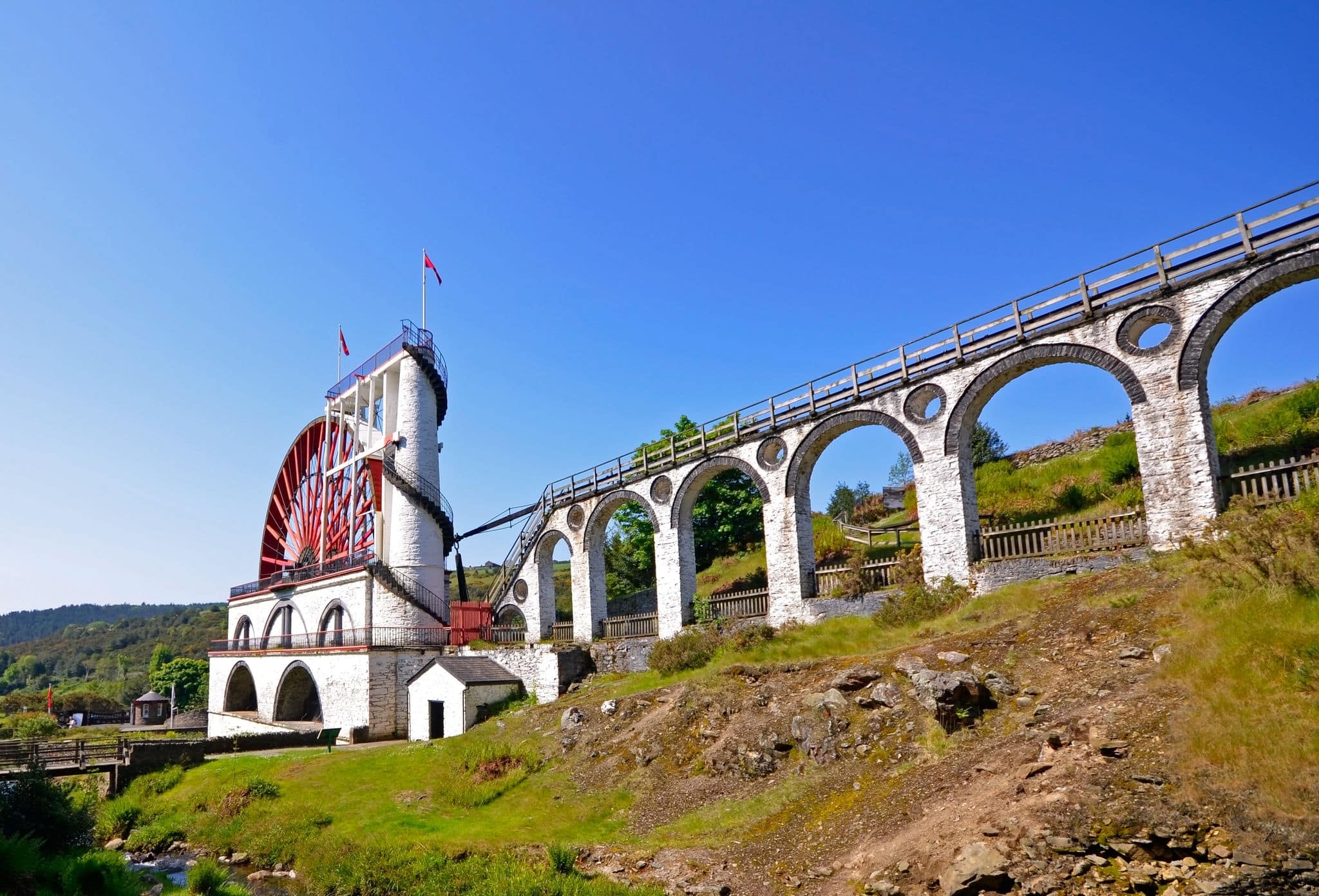 The Great Laxey Wheel with viaduct on sunny day - Isle of Man