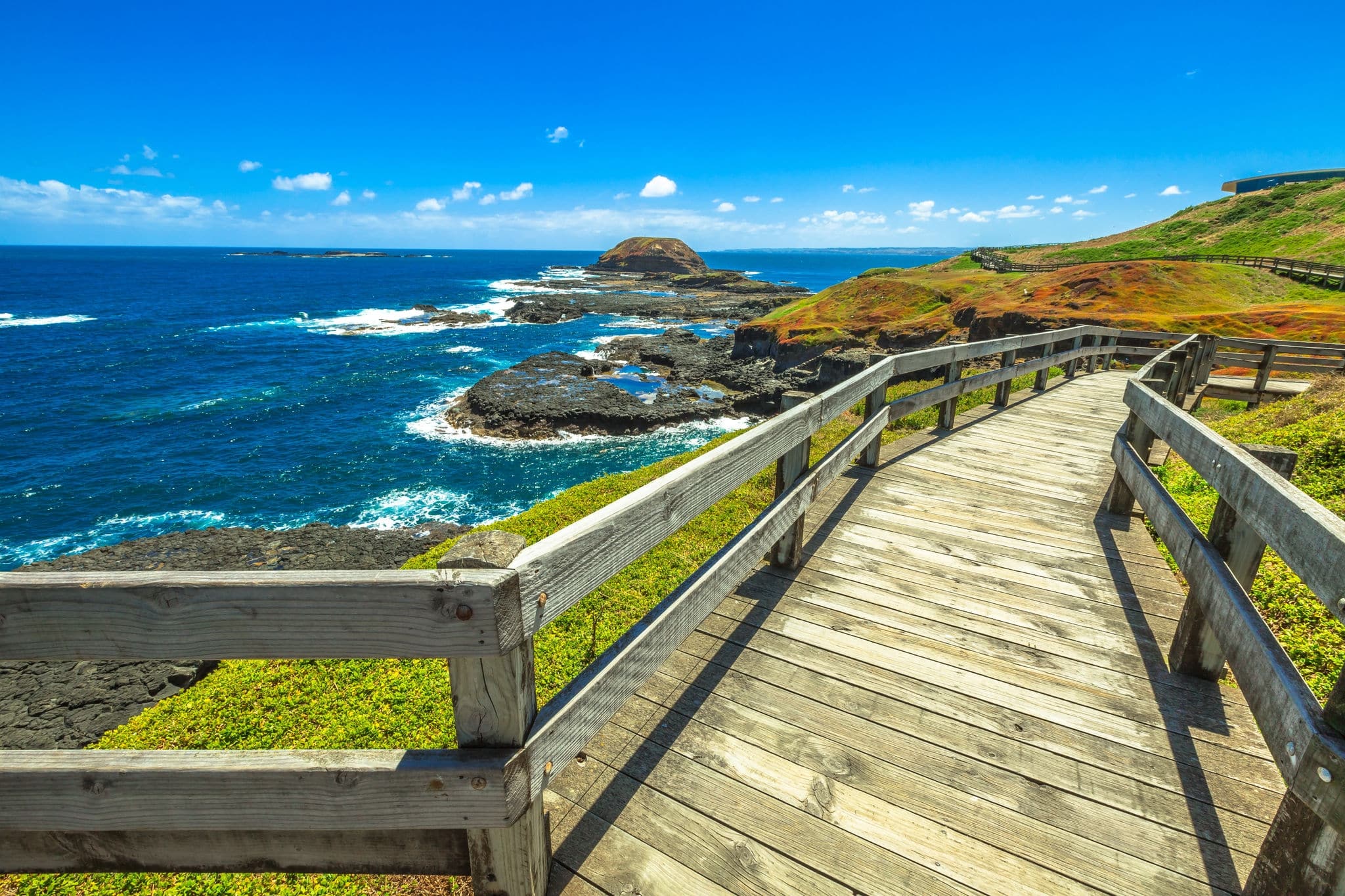 The boardwalks outside The Nobbies center overlook Seal Rocks. Grant Point, western tip of Phillip Island, Victoria, Australia.