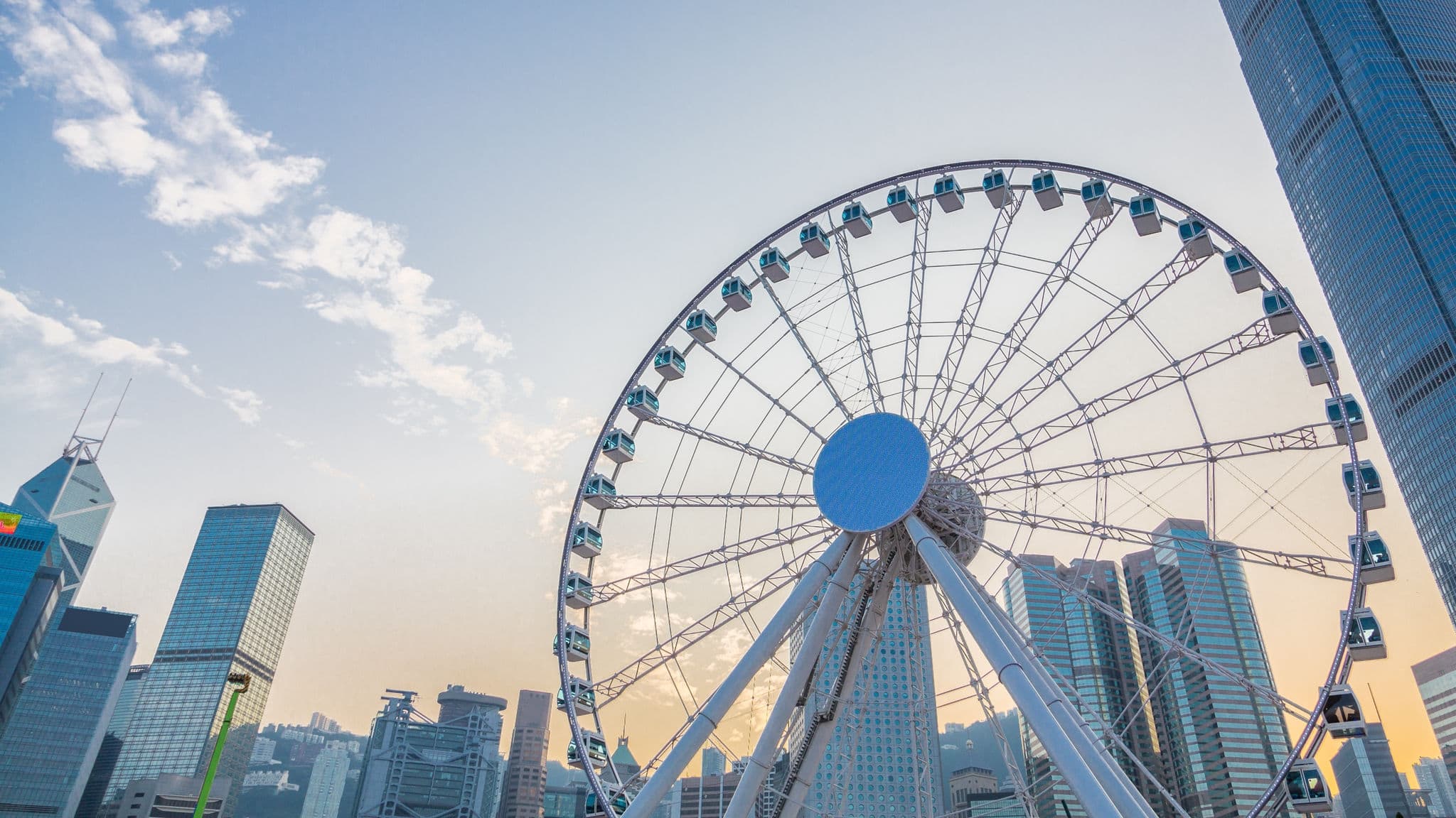 Ferris Wheel in Hong Kong, with landmark buildings.
