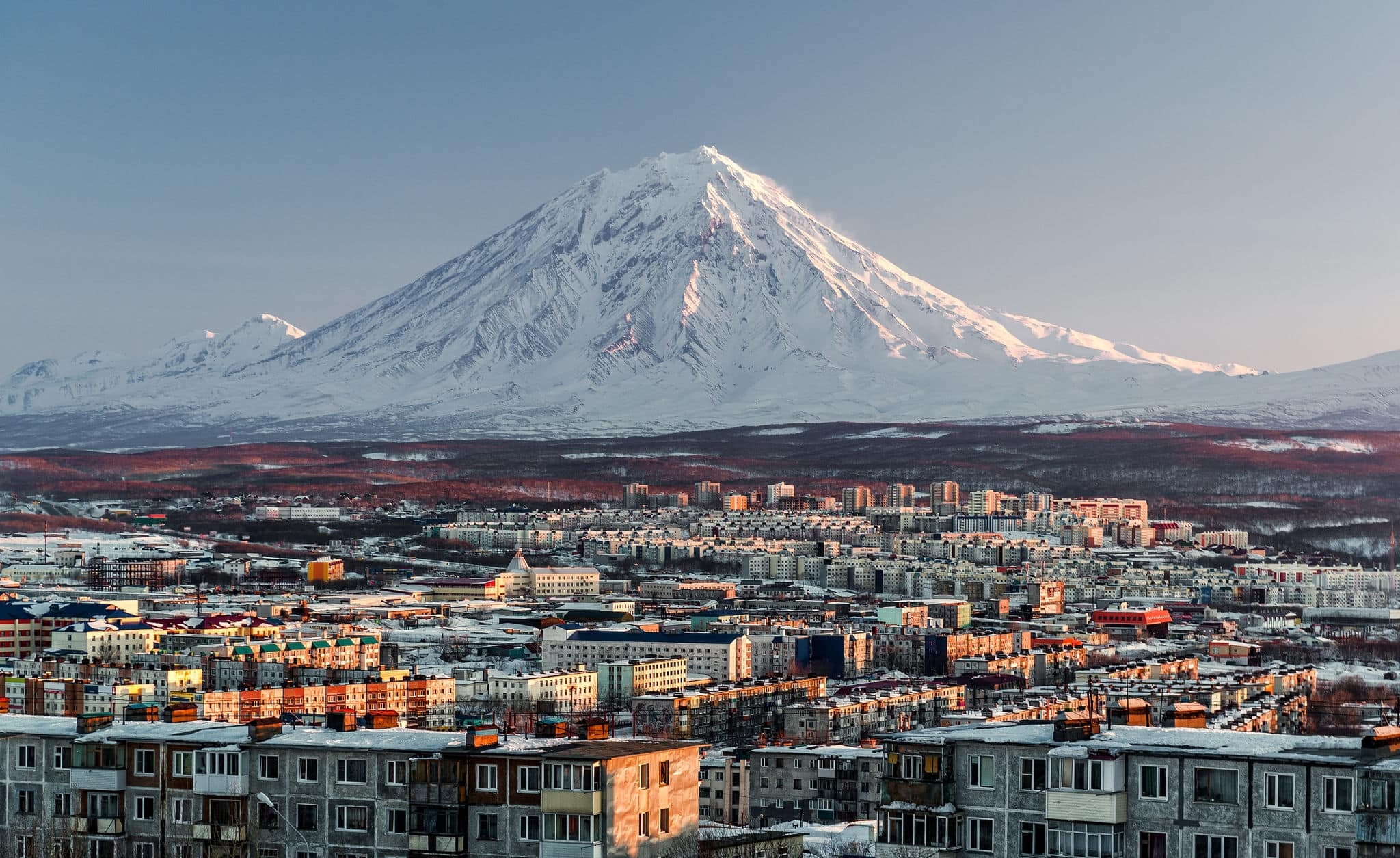Petropavlovsk-Kamchatsky cityscape and Koryaksky volcano at sunrise. Far East, Russia