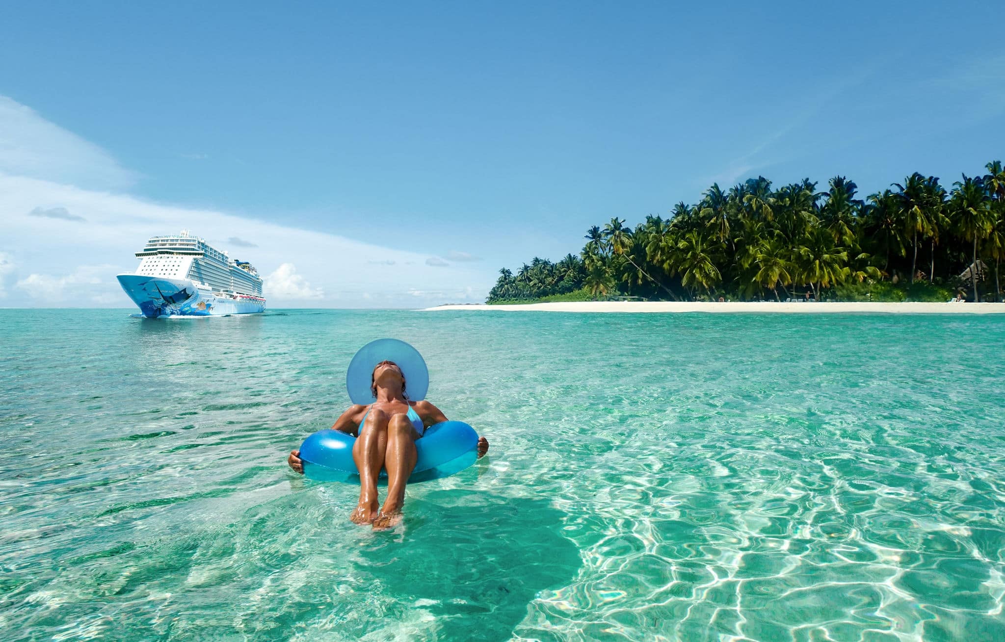 Woman floating on tube in water. 