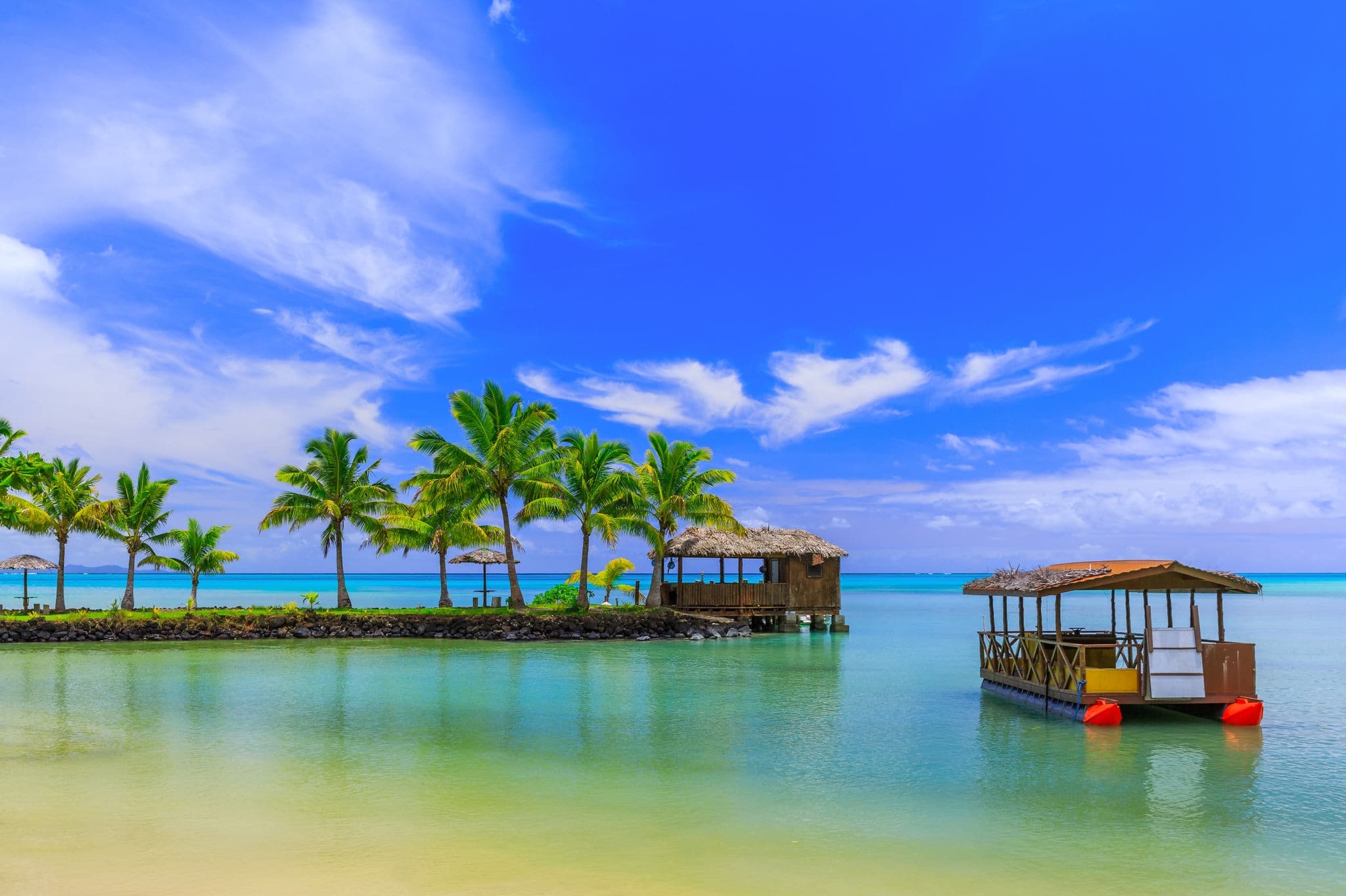 Apia, Samoa. Hut and boat by the beach.