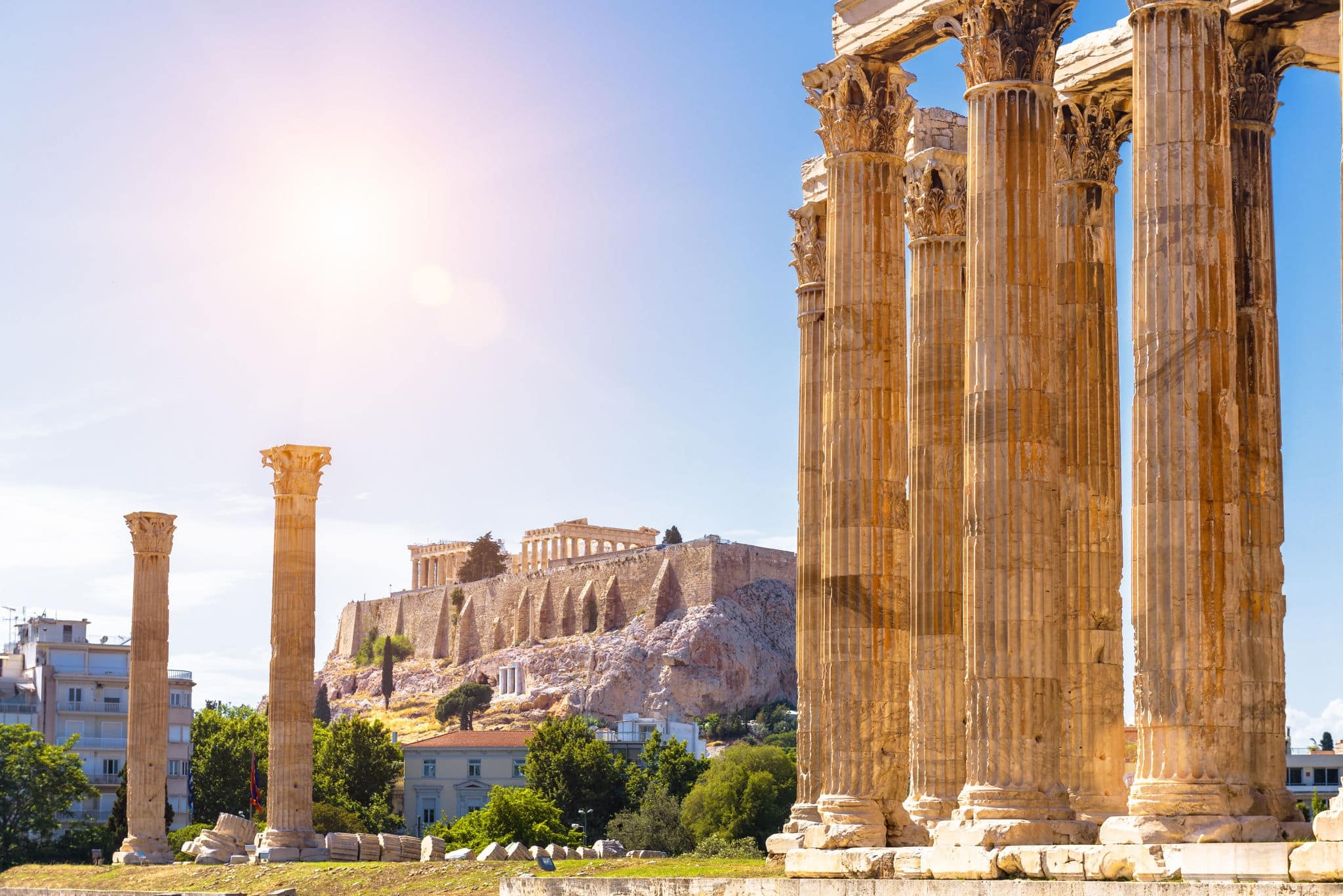 Athens view, Zeus temple overlooking Acropolis, Greece. Ancient Greek ruins, famous landmarks of Athens city. Scenery of great columns of classical building in Athens center. Travel in Greece theme.