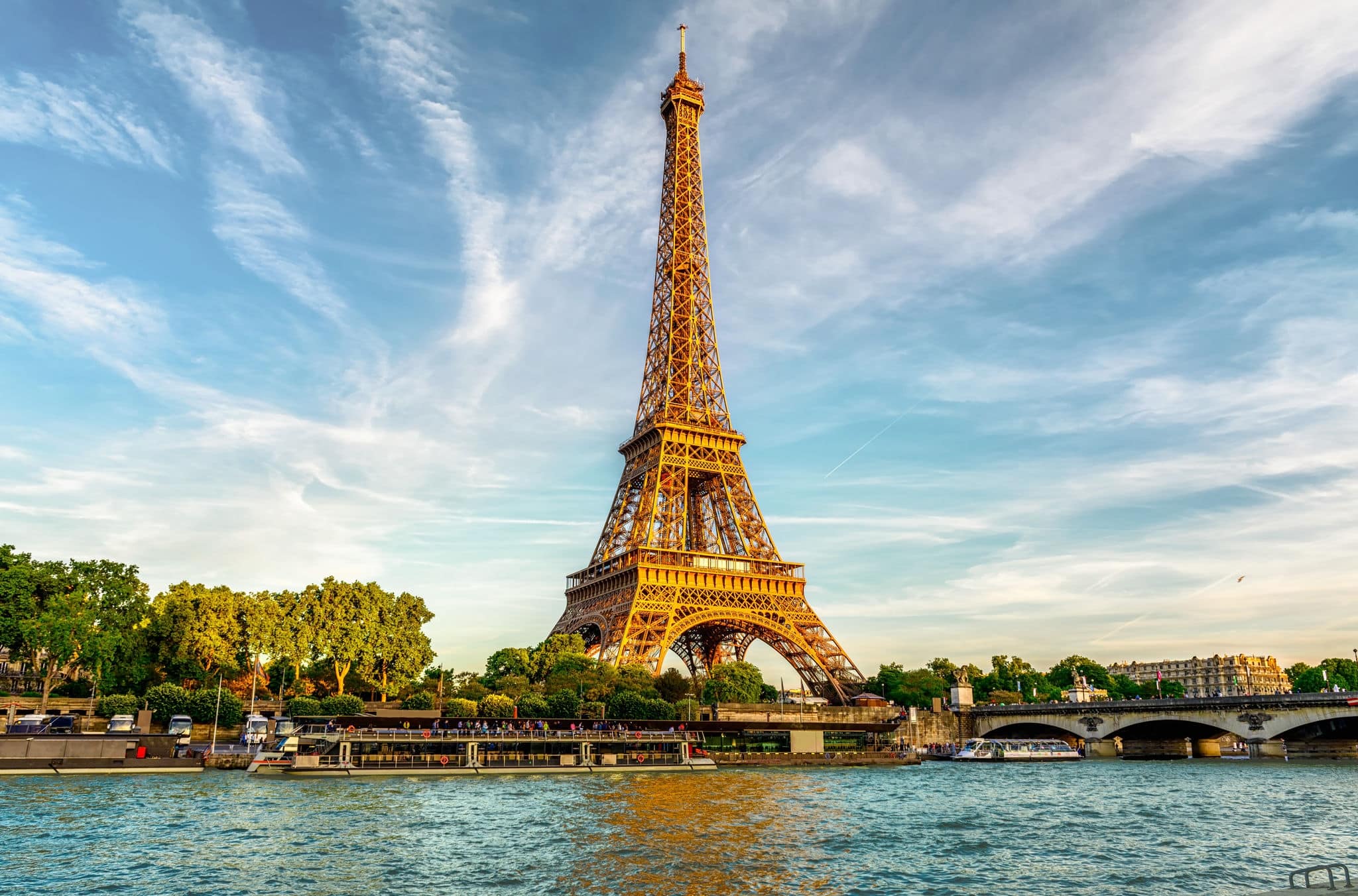 Paris Eiffel Tower and river Seine at sunset in Paris, France. Eiffel Tower is one of the most iconic landmarks of Paris.