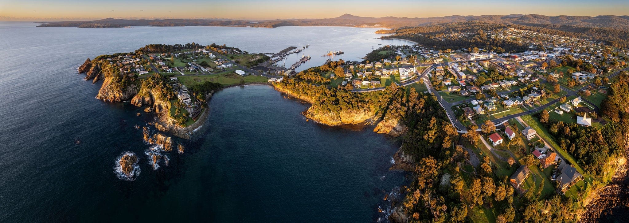 Dawn aerial panorama of the coastal town of Eden, NSW Australia
