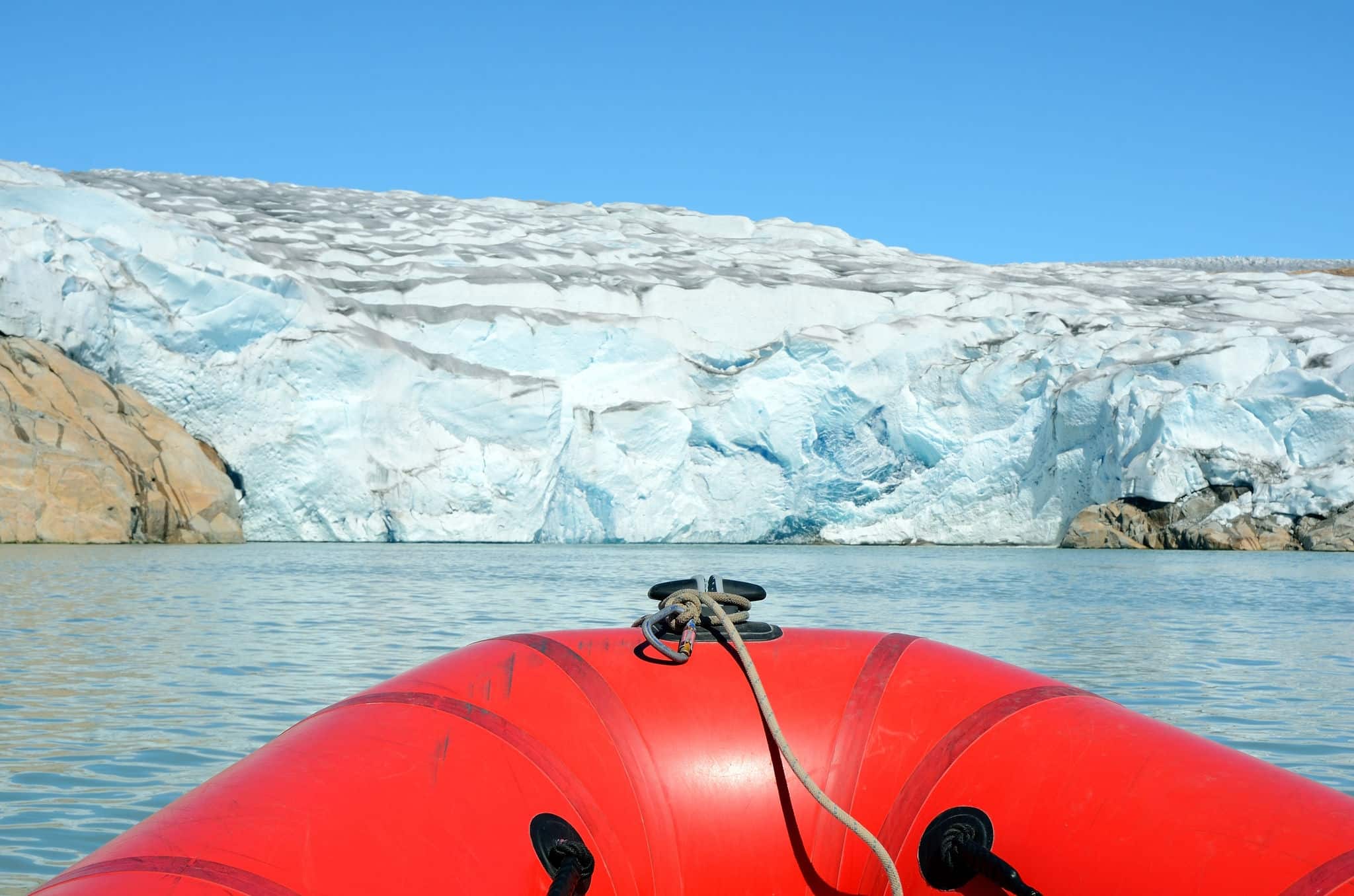 Sailing on an inflatable boat among the icebergs, Greenland.