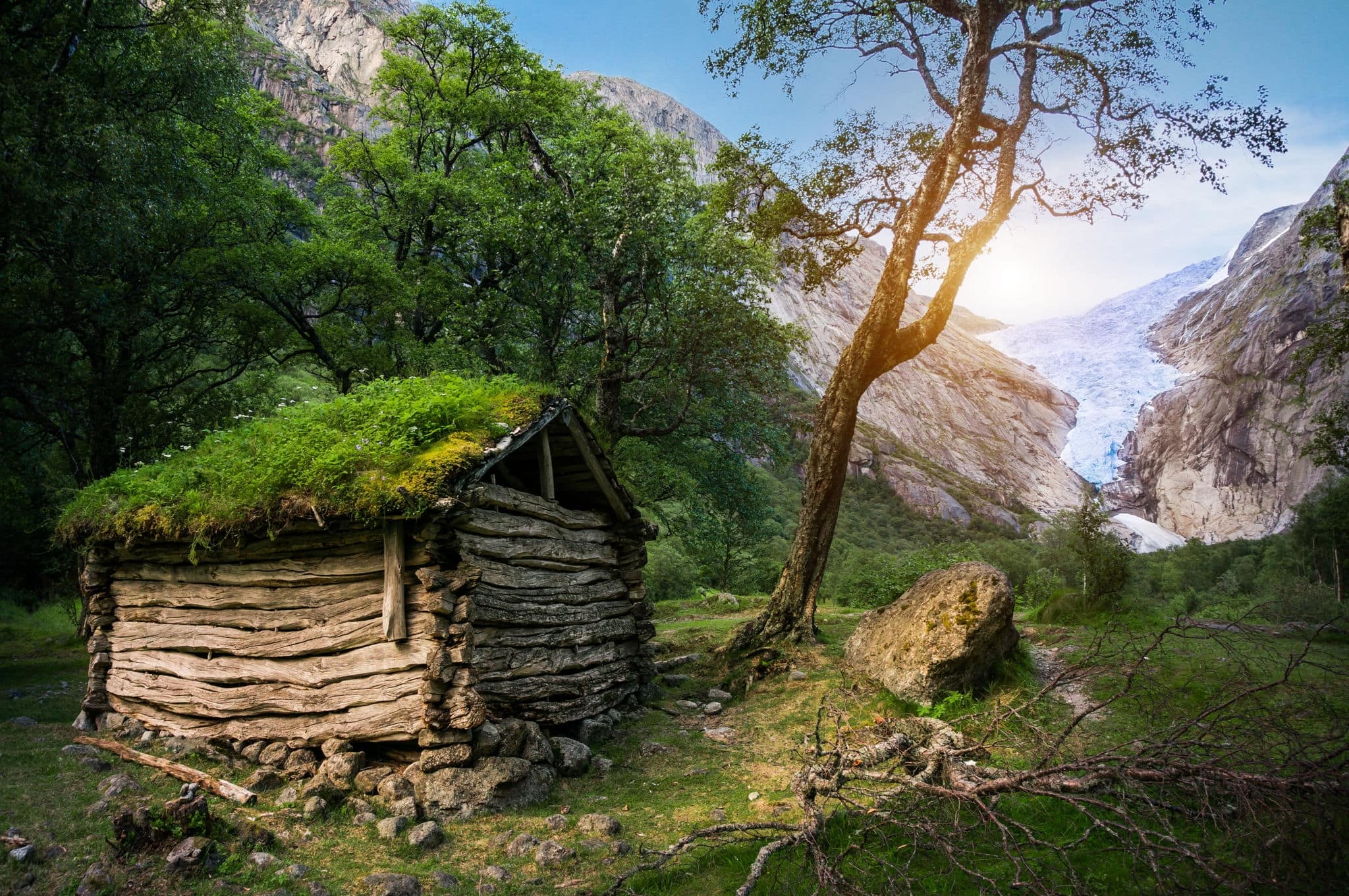 Norwegian typical grass roof wooden old house and Briksdal glacier panorama, as  in a Magical forest 