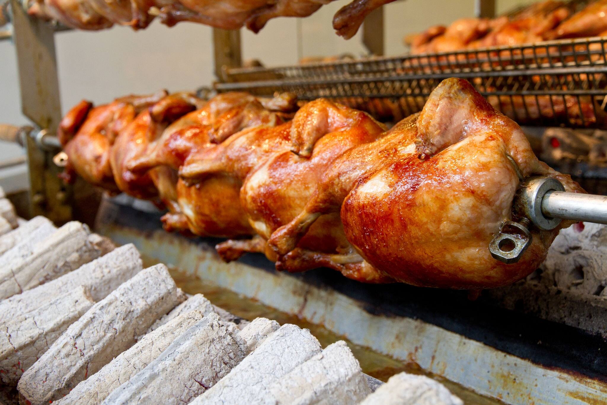 Chicken being cooked over coal