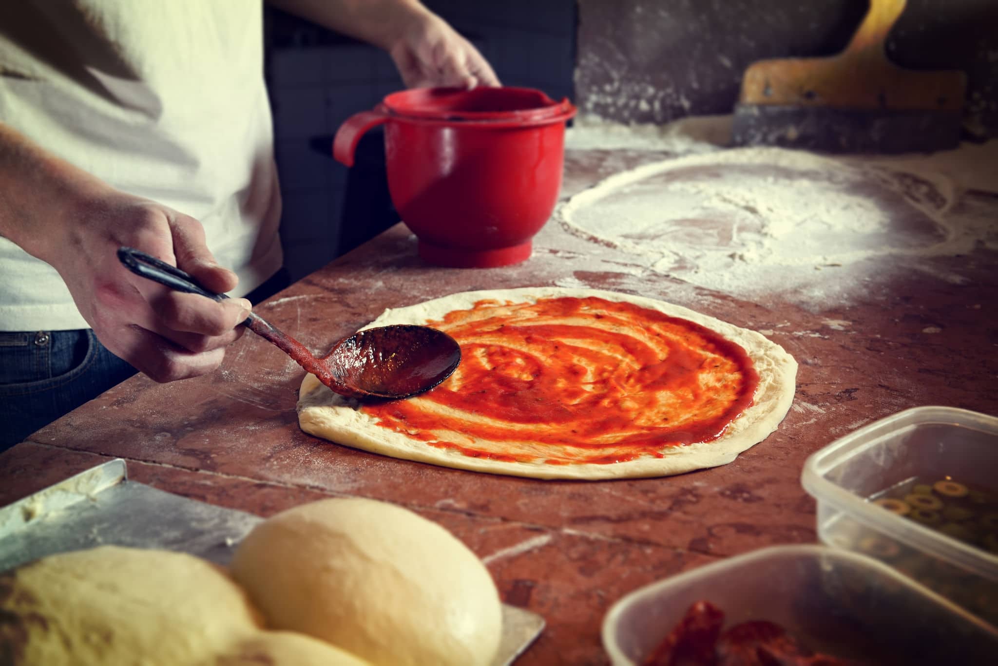 Fresh original Italian raw pizza, preparation in traditional style. 