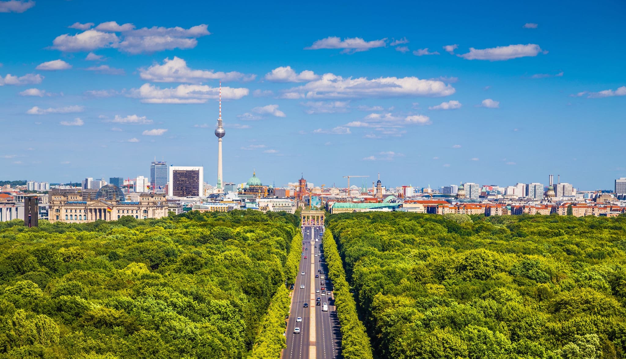 Aerial view of Berlin skyline panorama with Grosser Tiergarten public park on a sunny day with blue sky and clouds in summer seen from Berlin Victory Column (Berliner Siegessaeule), Germany
