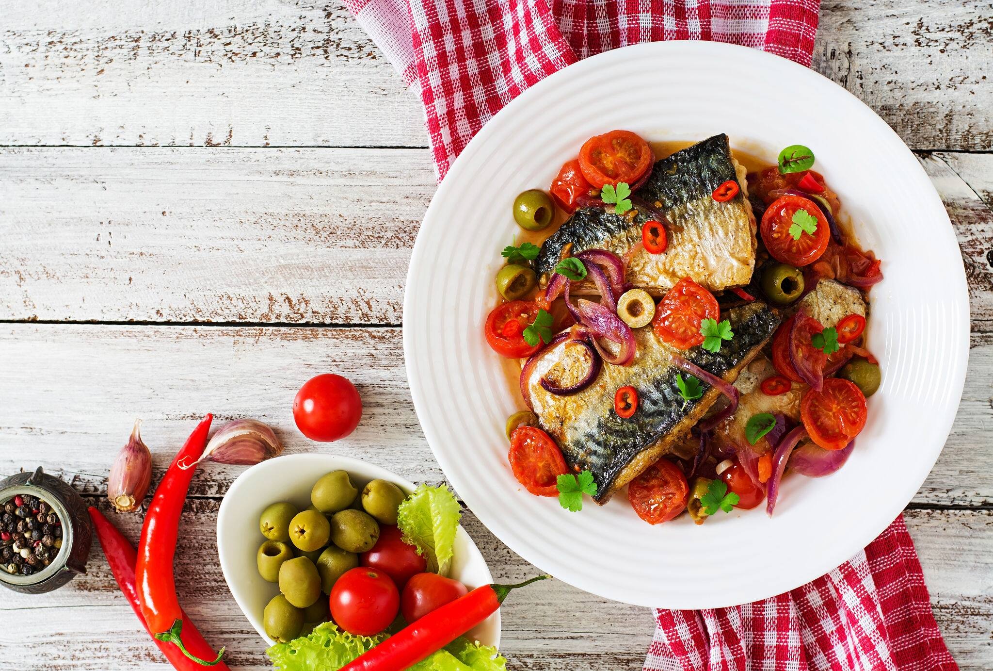 Grilled mackerel with vegetables in Mediterranean style. Top view