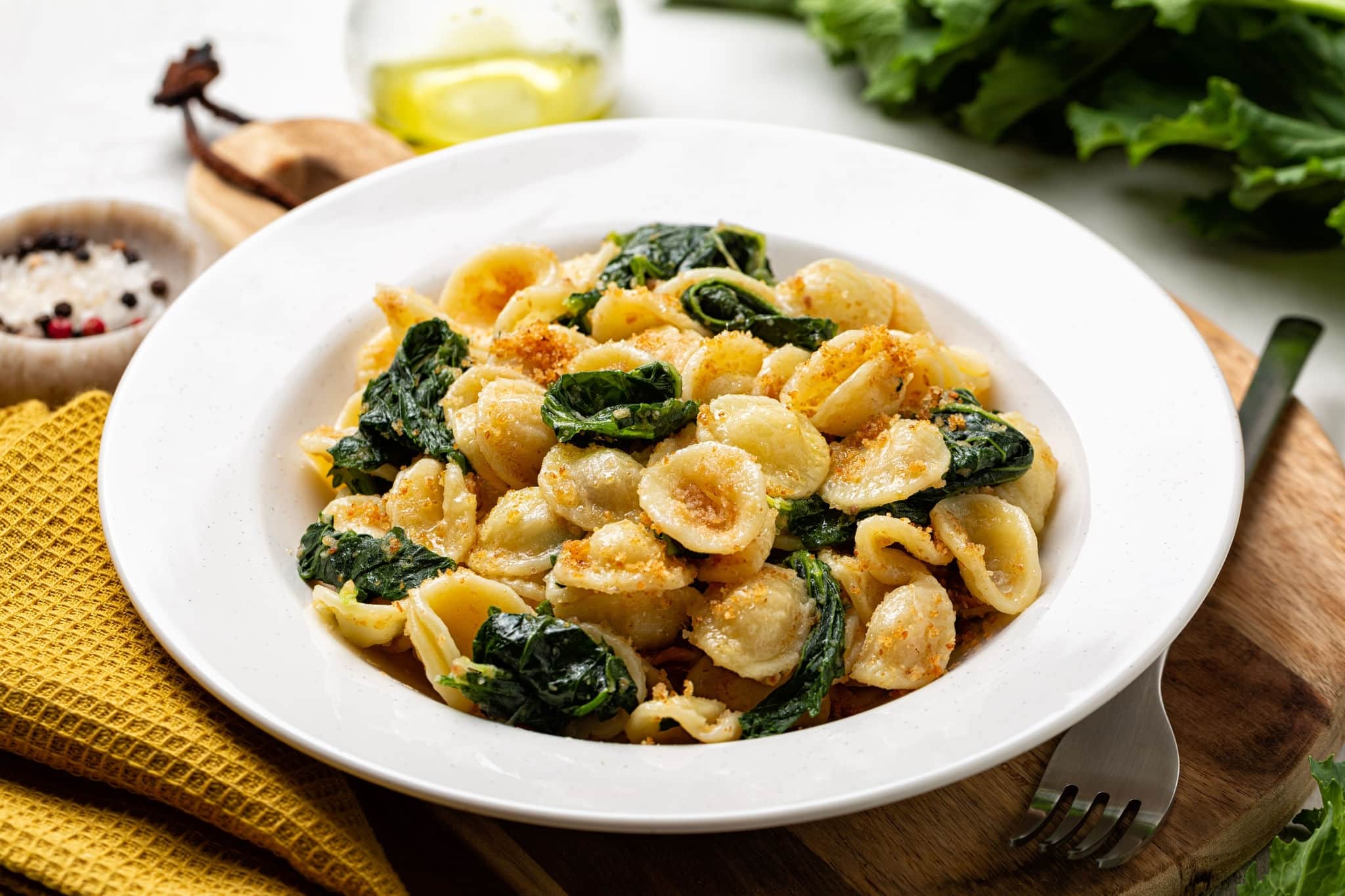 Close-up of Italian pasta Orecchiette con le cime di rapa e le acciughe, popular in Southern Italy, typical for Apulia. Made with anchovy, bread crumbs and rapini, broccoli rabe or turnip greens