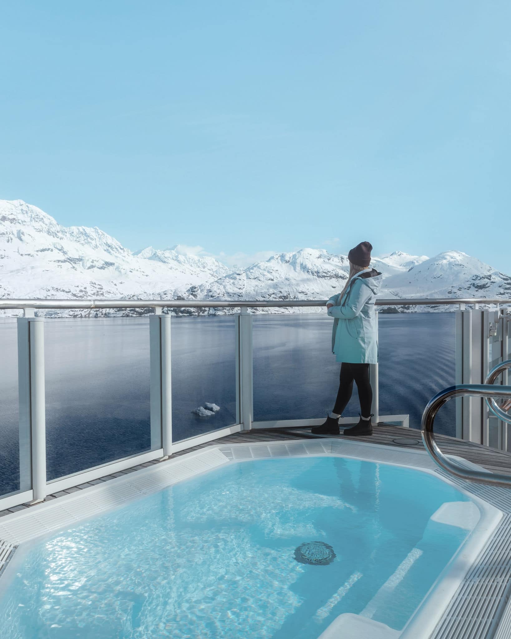 Woman looking at glaciers in Alaska. 