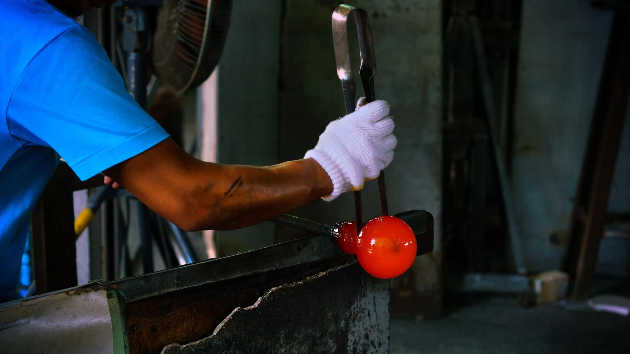 Man Craft wearing white glove forming on Hot Glass 