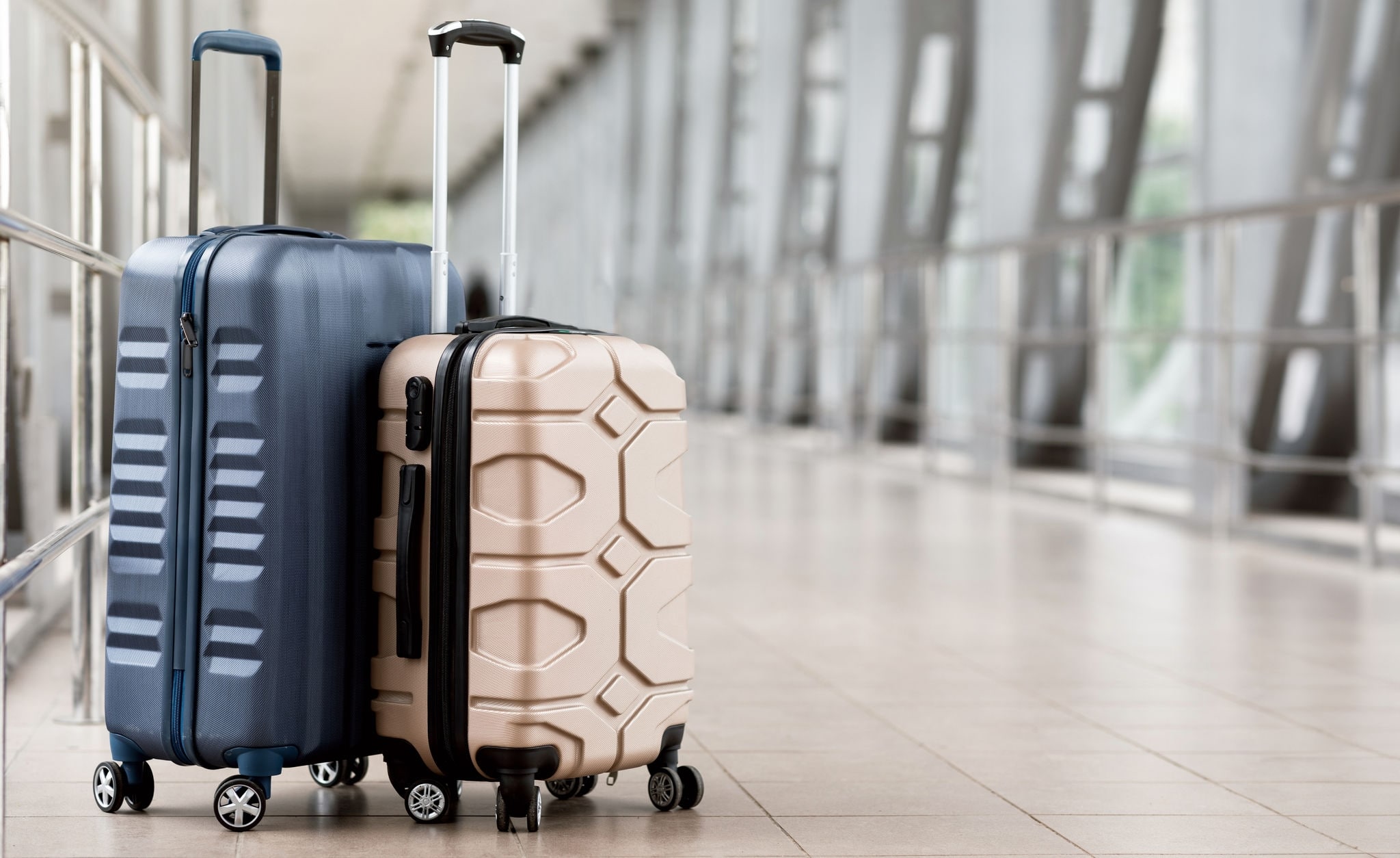 Travel Fashion. Closeup Shot Of Two Plastic Suitcases Standing At Empty Airport Corridor, Stylish Luggage Bags Waiting At Terminal Hall, Banner For Air Travelling And Vacation Booking Concept