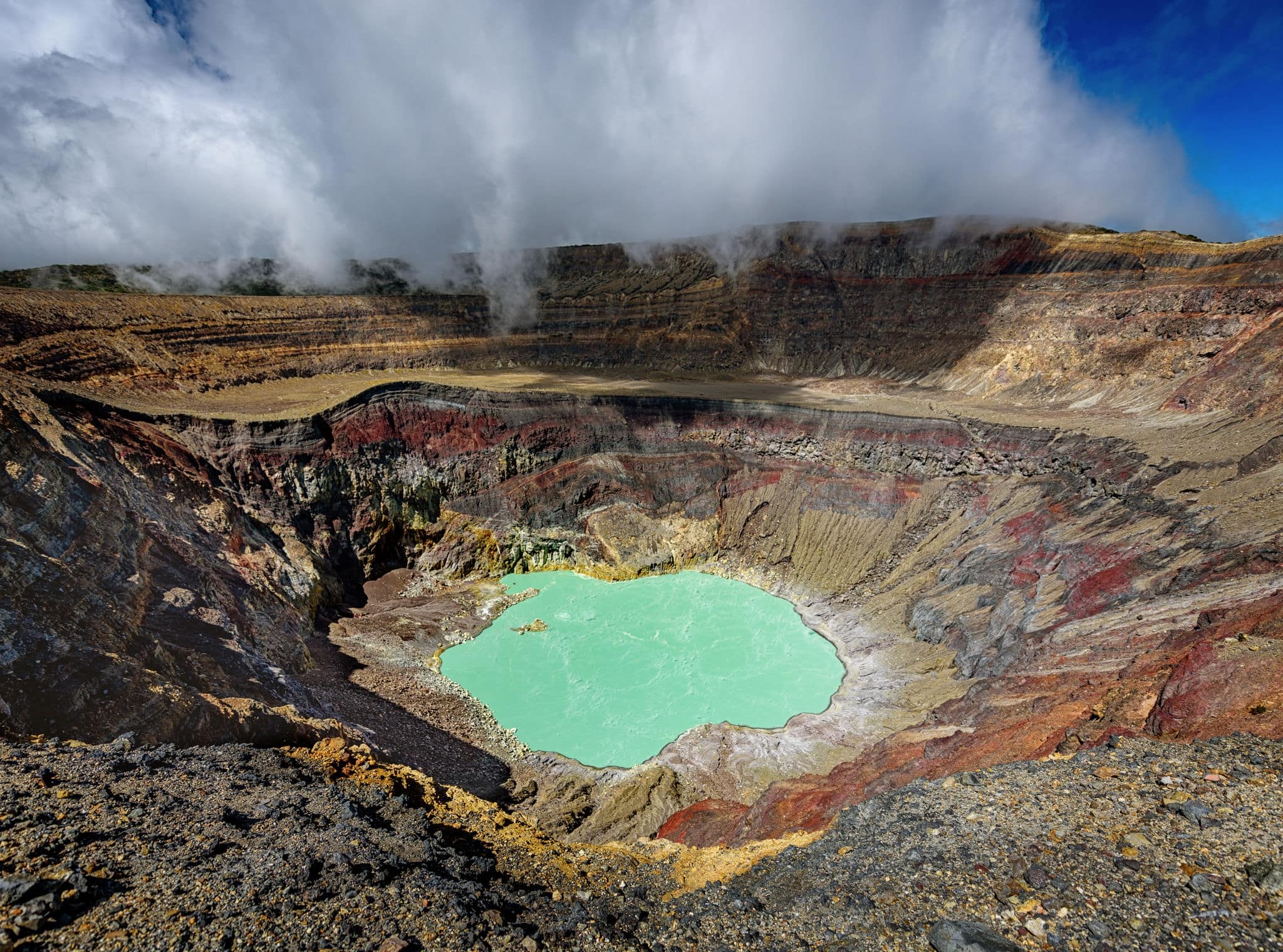 Ilamatepec lagoon on the active Santa Ana Volcano in El Salvador, beautiful mint green laguna in the volcano with clouds and sulfur