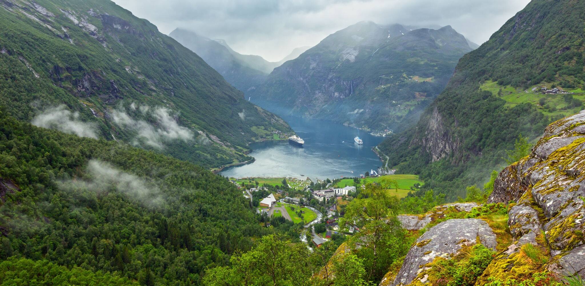 Geiranger Fjord cloudy summer panorama from above Dalsnibba mount, Norway.