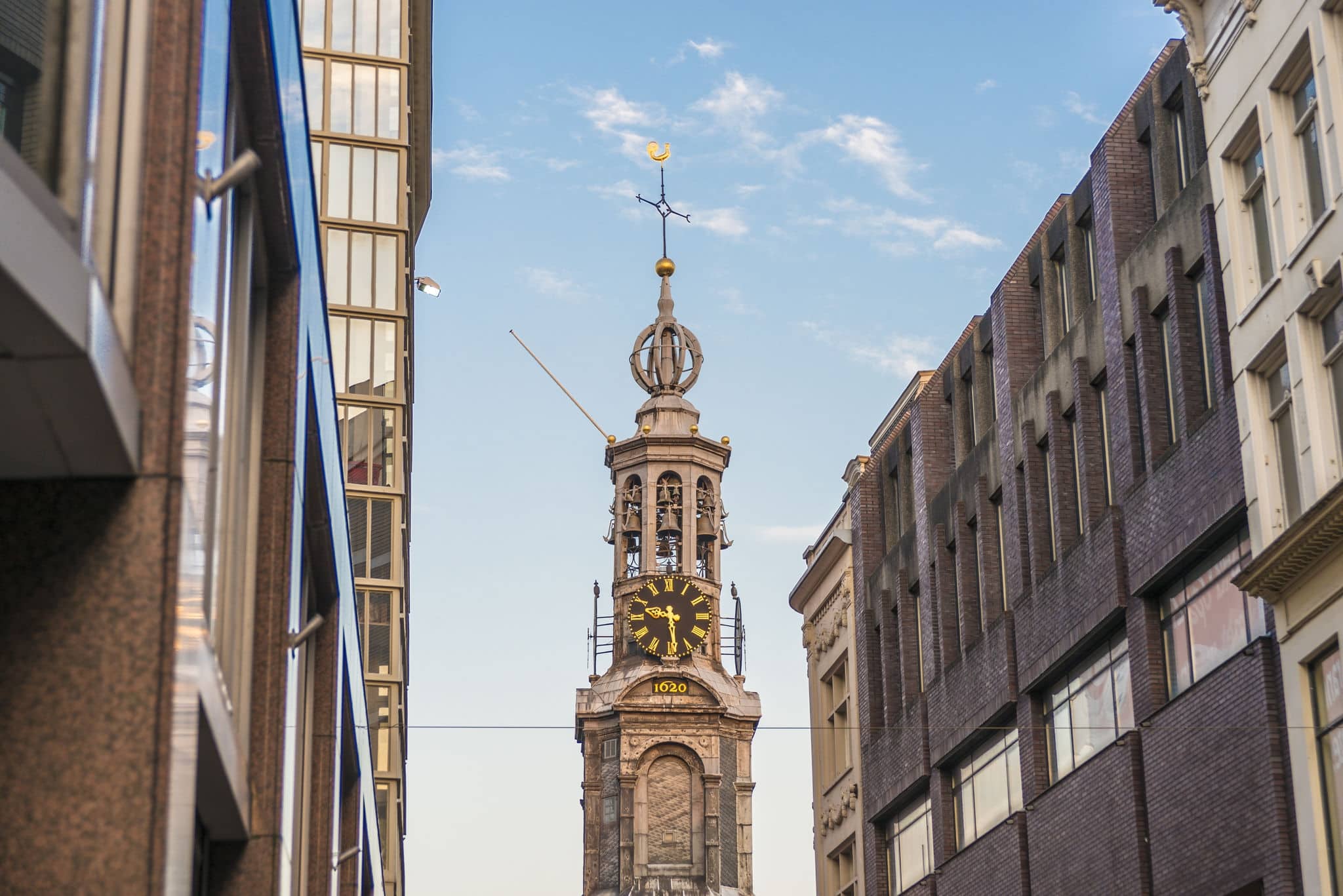 The Munttoren (Mint Tower) Muntplein square, where the Amstel river and the Singel canal meet, near the flower market and the end of Kalverstraat shopping street in Amsterdam, Netherlands.