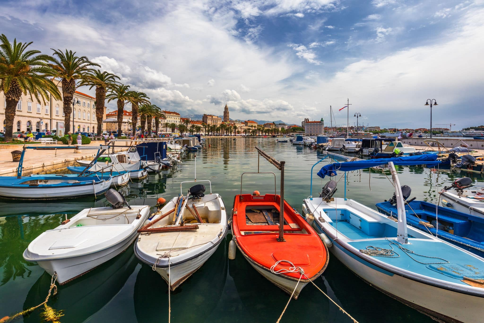 City of Split with colorful fishing boats in harbor, Dalmatia, Croatia. Waterfront view of fishing boats at mediterranean scenery in old roman town Split, Croatia. 