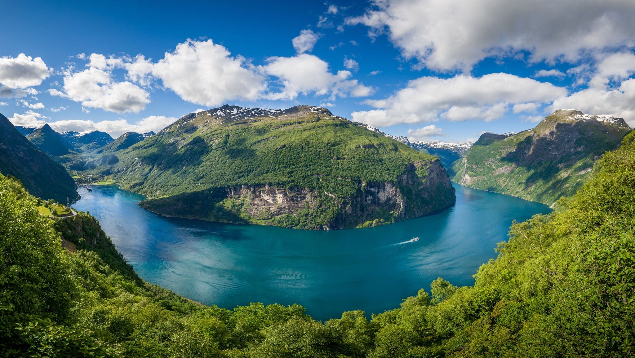 Panoramic aerial wide angle landscape of Geiranger fjord from mountain viewpoint. High resolution panorama, Geirangerfjord, Norway.
