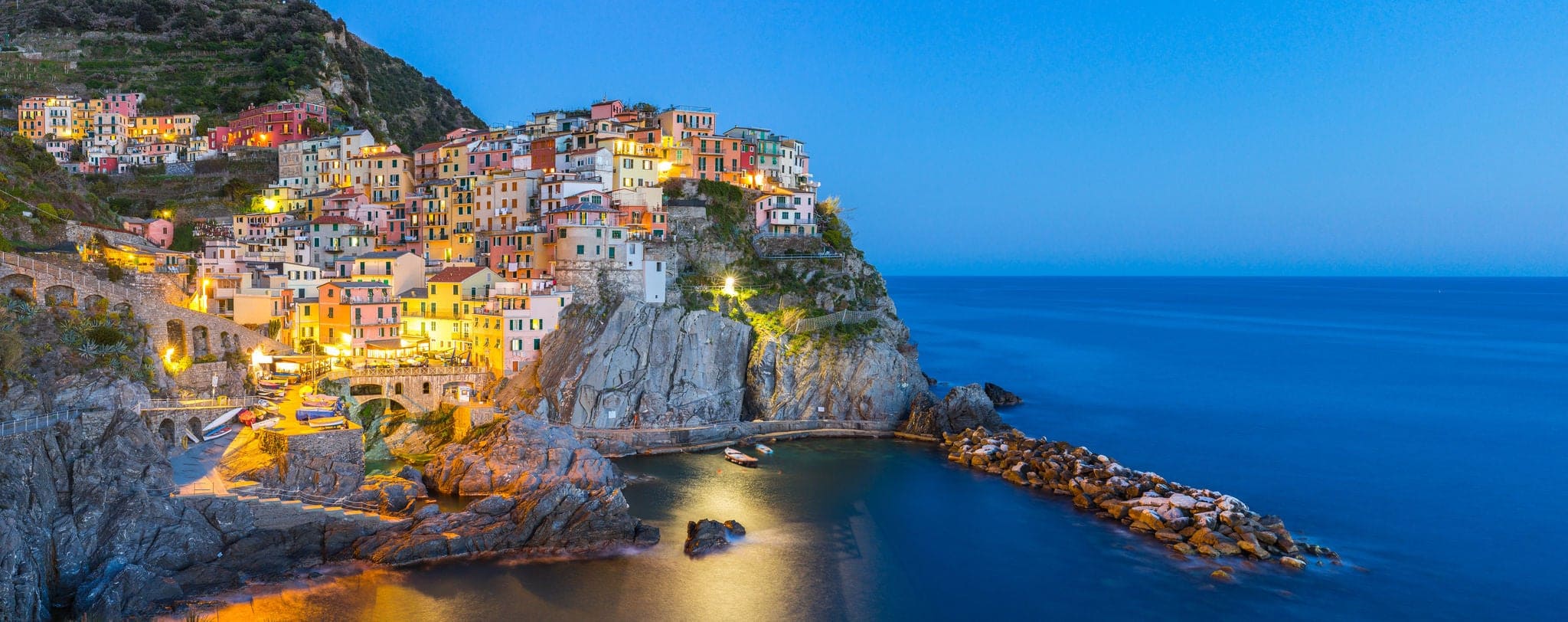 Panorama view of Manarola village one of Cinque Terre at night in La Spezia, Italy.