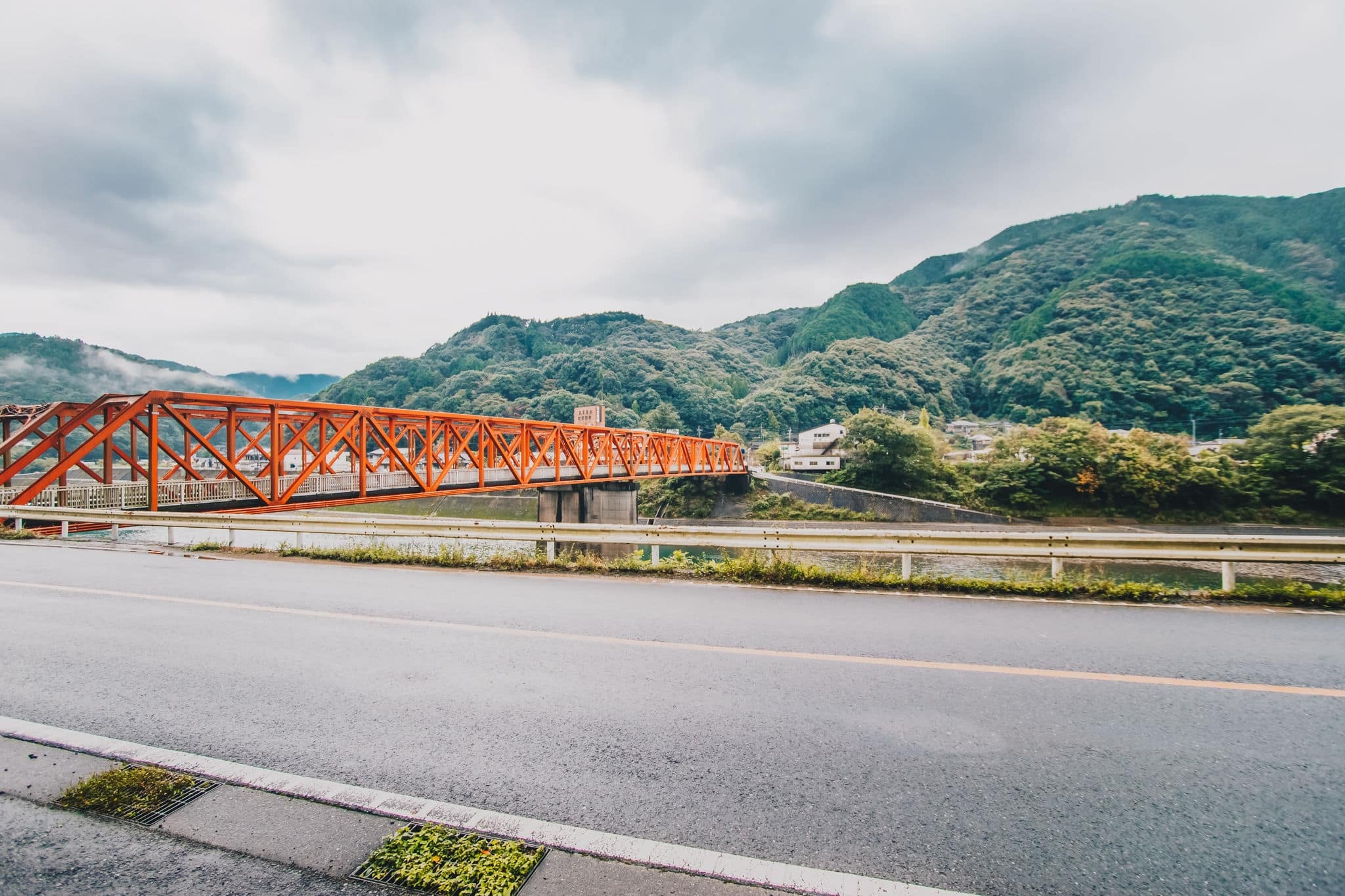 Red iron bridge at Sakamotomachi in heavy rainy day, storm and big cloud is coming, Sakamoto, Yatsushiro, Kumamoto Prefecture.