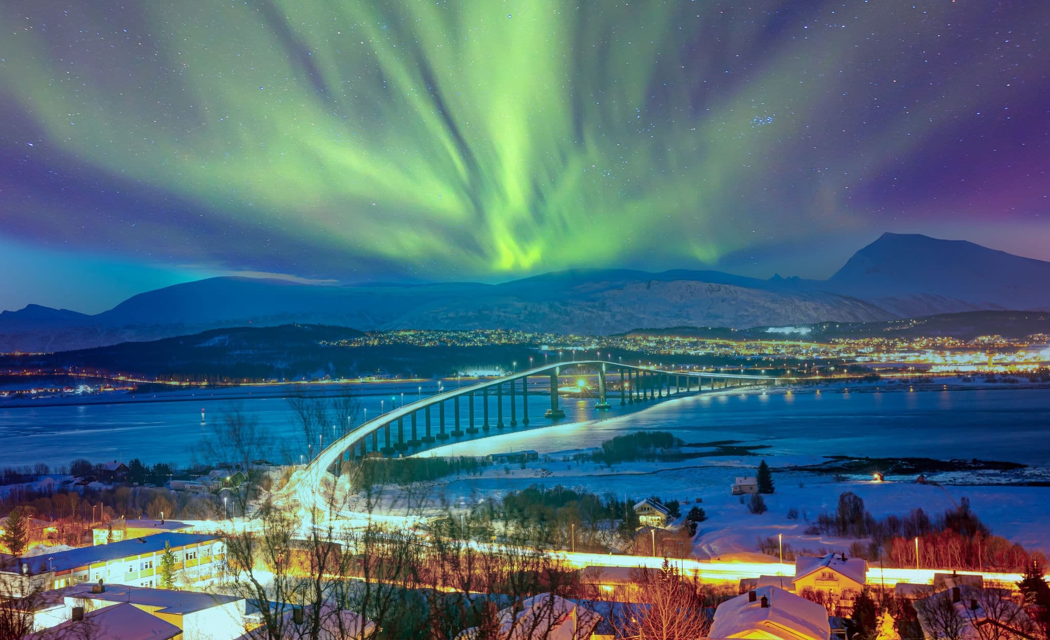 Aurora borealis or Northern lights in the sky over Tromso with Sandnessundet Bridge - Tromso, Norway