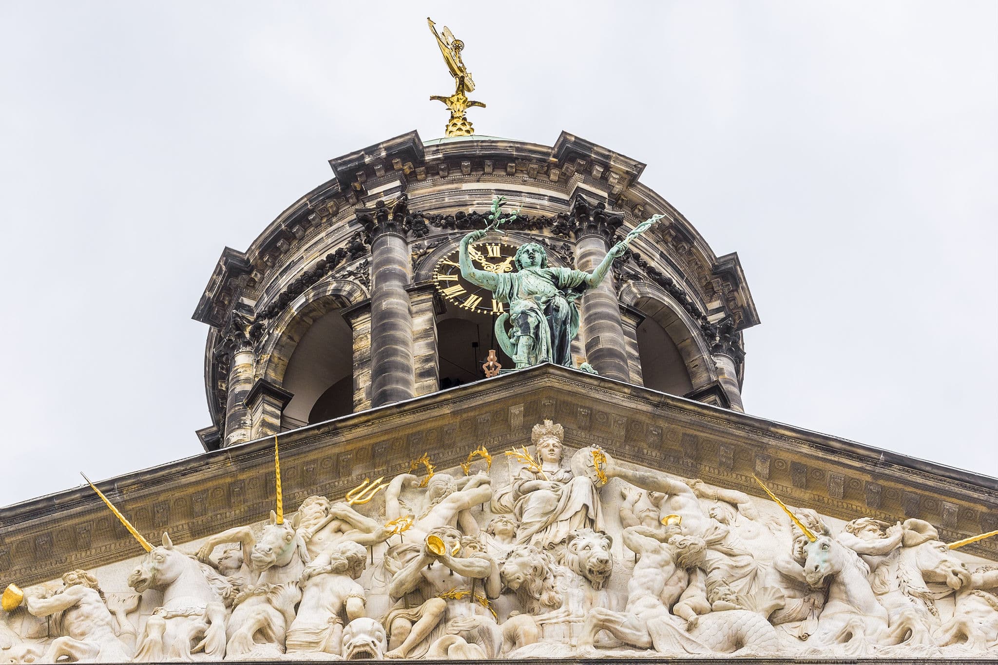 Parts of Royal Palace building (Koninklijk Paleis) at the Dam Square in Amsterdam, Netherlands. Palace in Holland classicism style was built as a city hall during the Dutch Golden Age in 1648 - 1655.