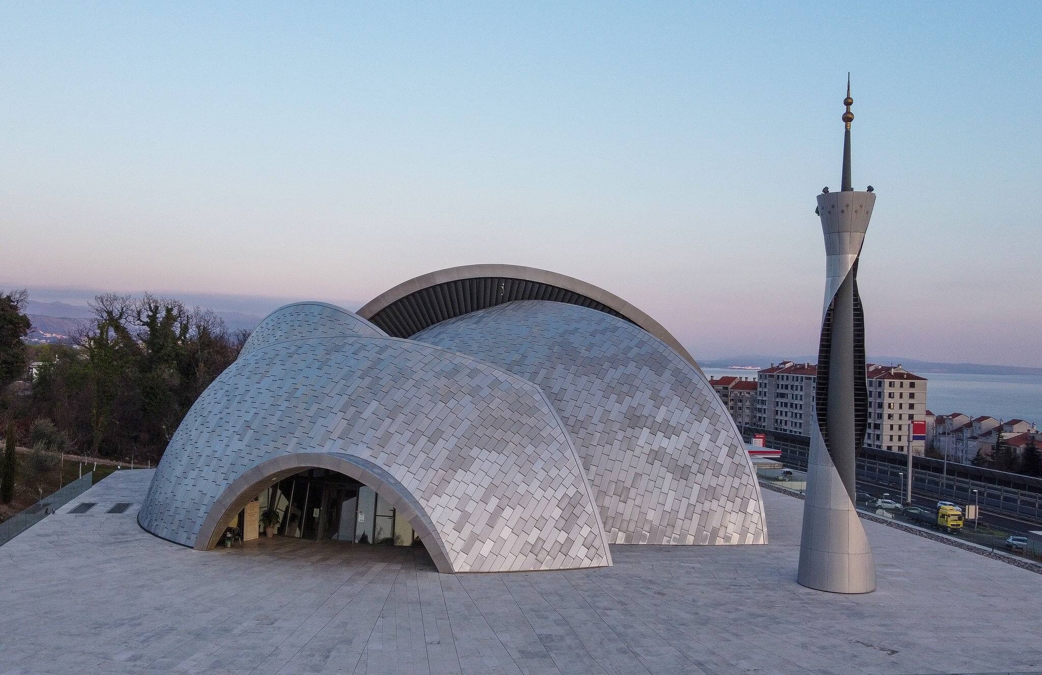 Beautiful modern mosque of islamic architecture, Islamic Center of Rijeka, Croatia, aerial view from drone at sunset.