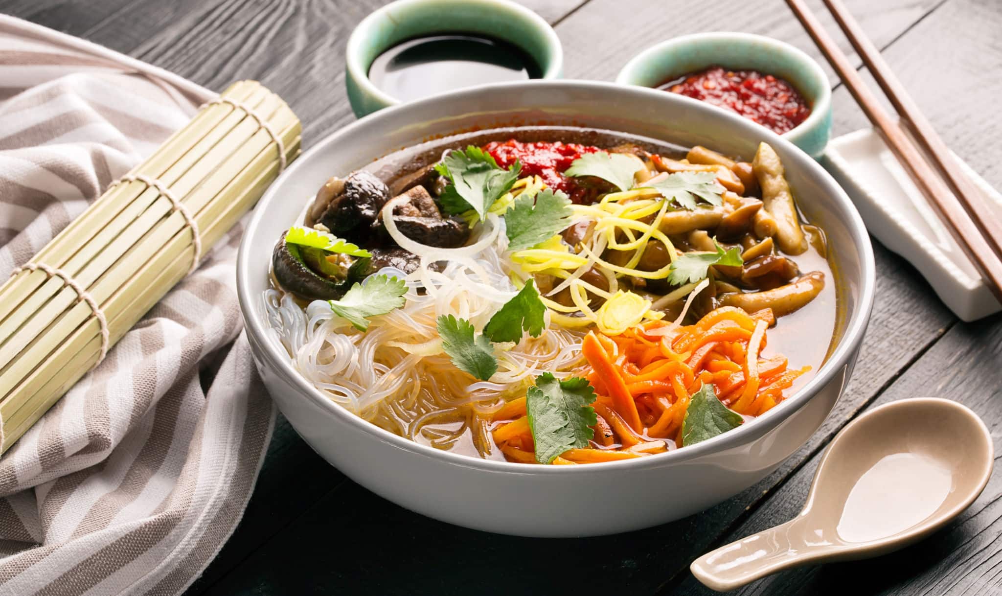 Traditional chinese soup with noodles, mushrooms and vegetables