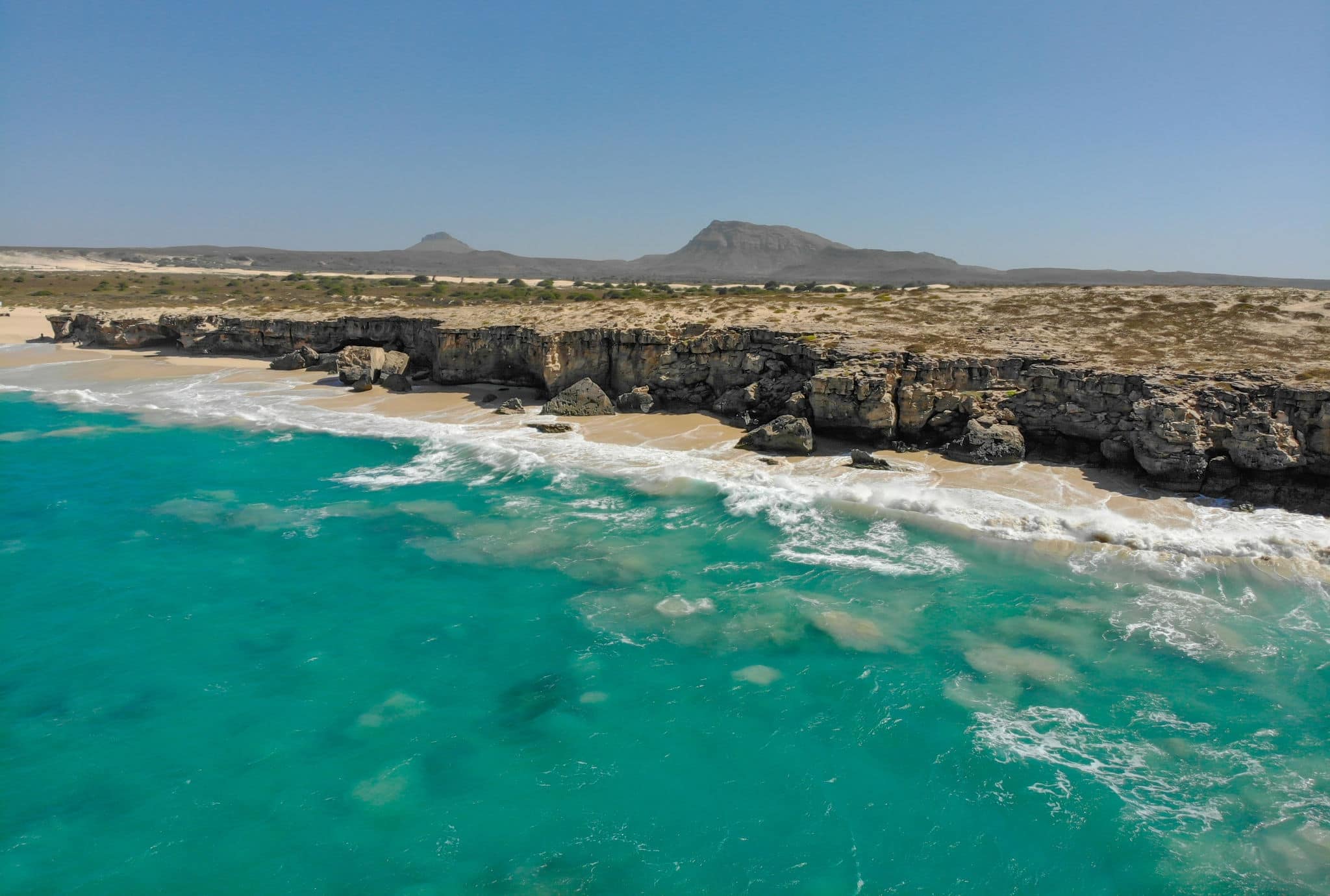 Coast of Boa Vista - paradise island next to the west coast of Africa. Nice waves and surf around the shore of Cape Verde island. Drone image of the Boa vista coast. Perfect sunny weather!