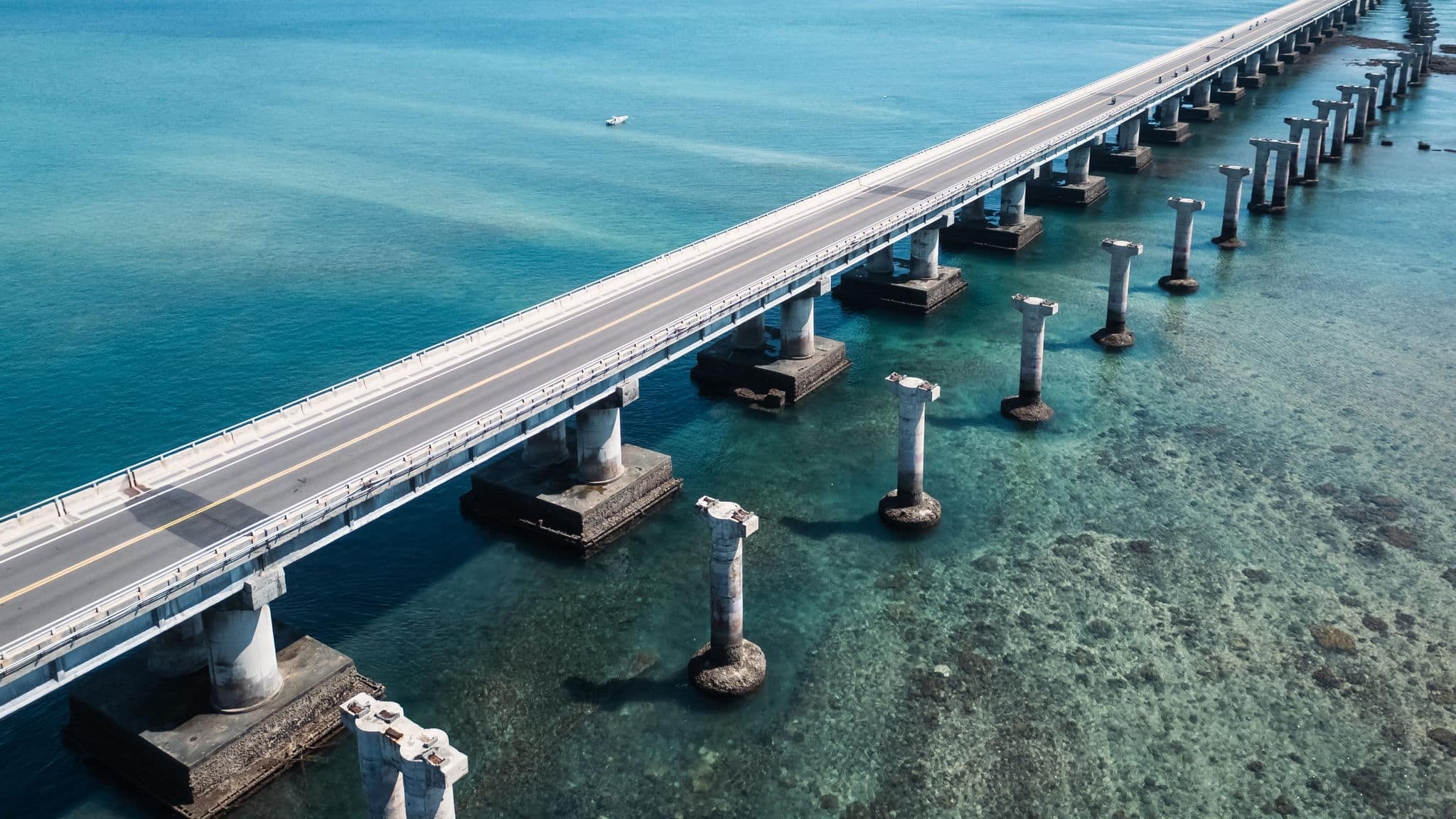 Penghu, Taiwan - July 27, 2024: From an aerial perspective, capturing the Penghu Cross-Sea Bridge, showcasing the bridge pier ruins and the rich variations of the sea surface.