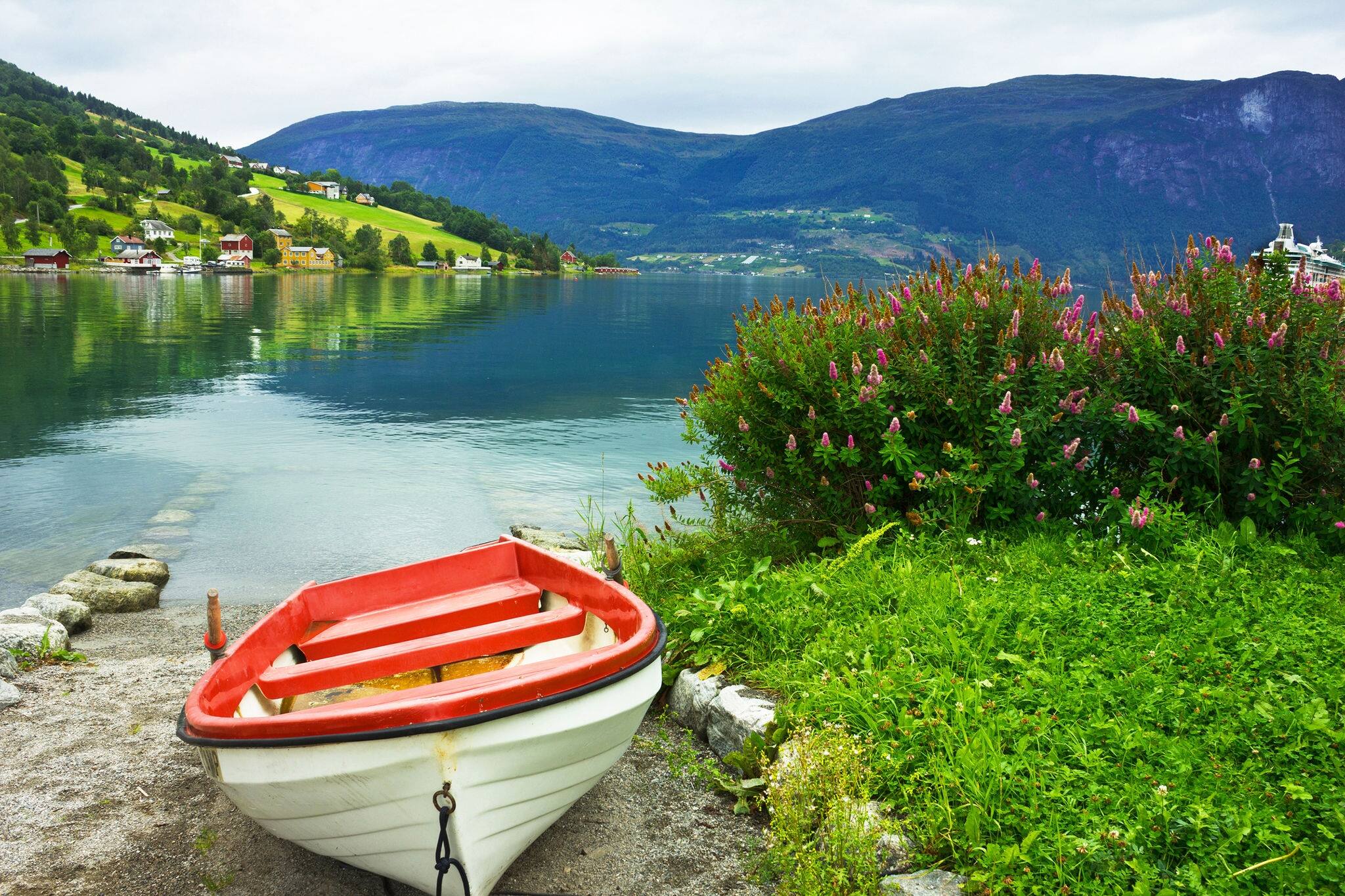 Boat on the beach of village Olden in Norwegian fjords.