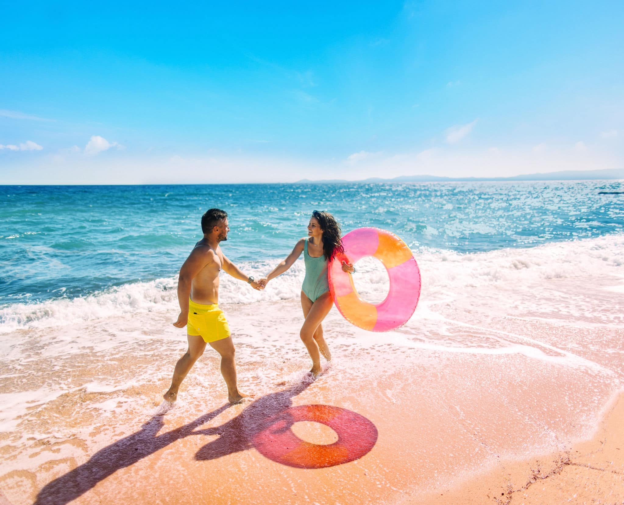 Photo of smiling couple having fun at the beach
