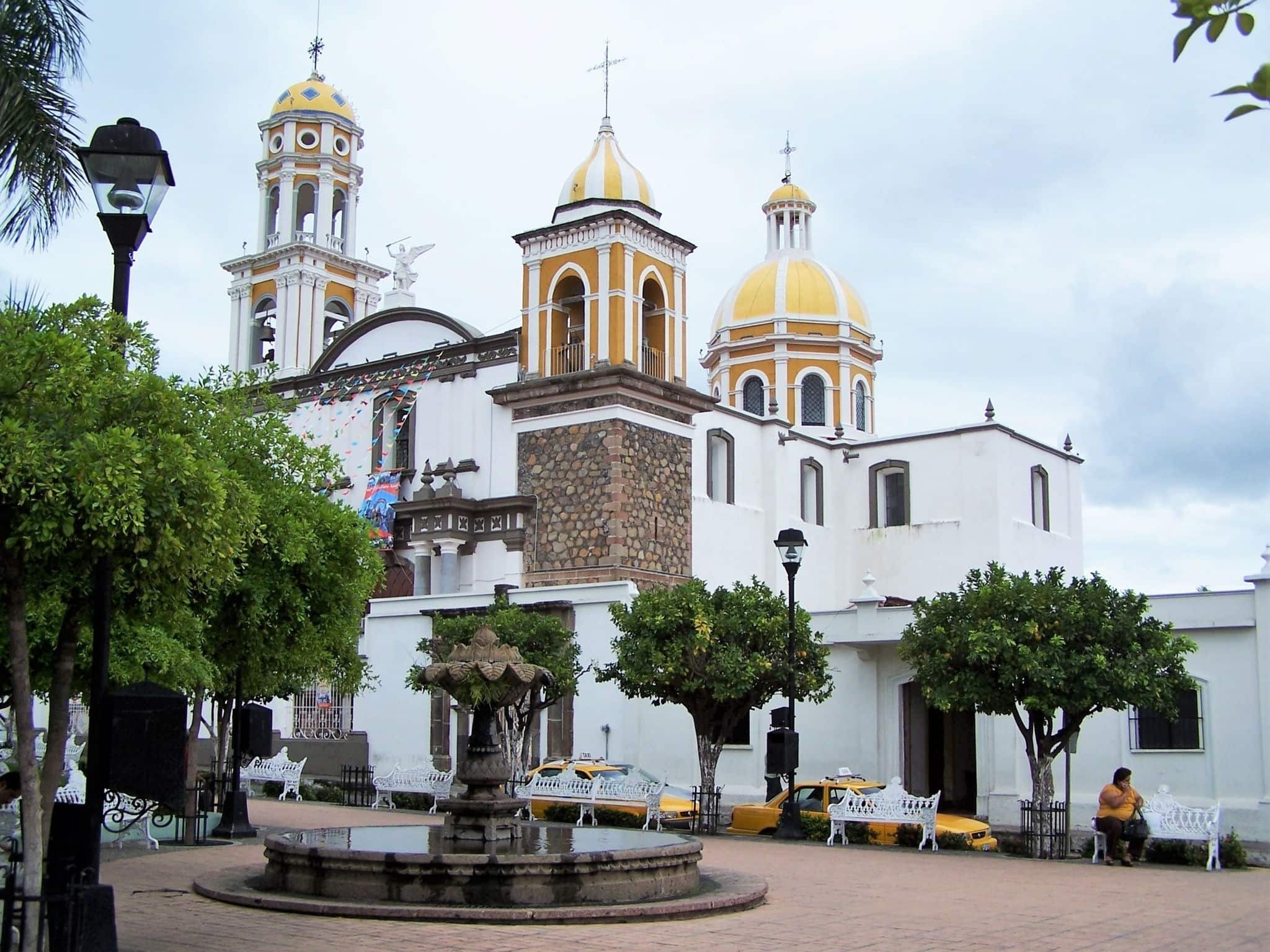 Central plaza in Colima, Mexico, with fountain and yellow domed church