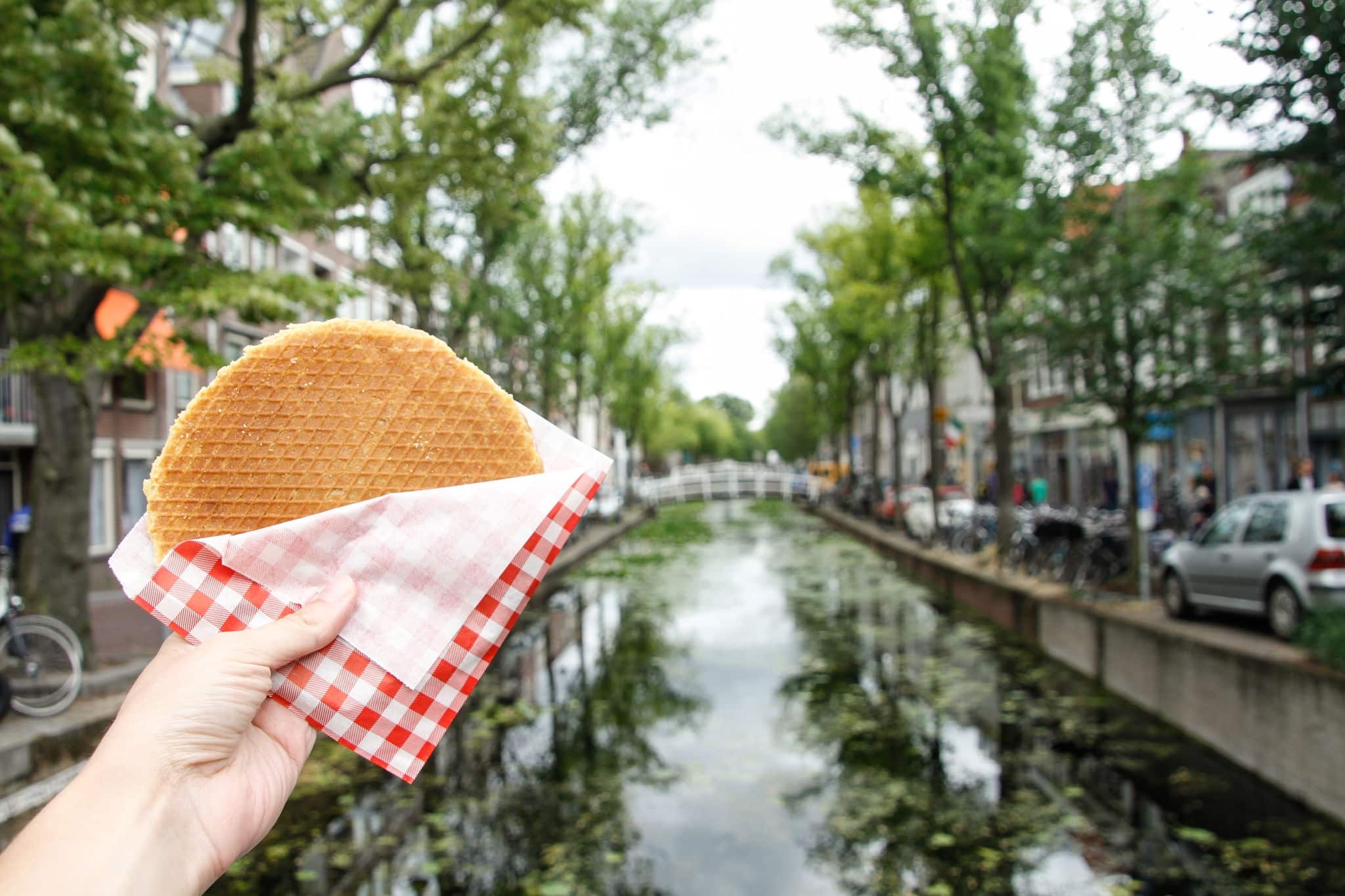 Typical Dutch stroopwafel with the canal in the background