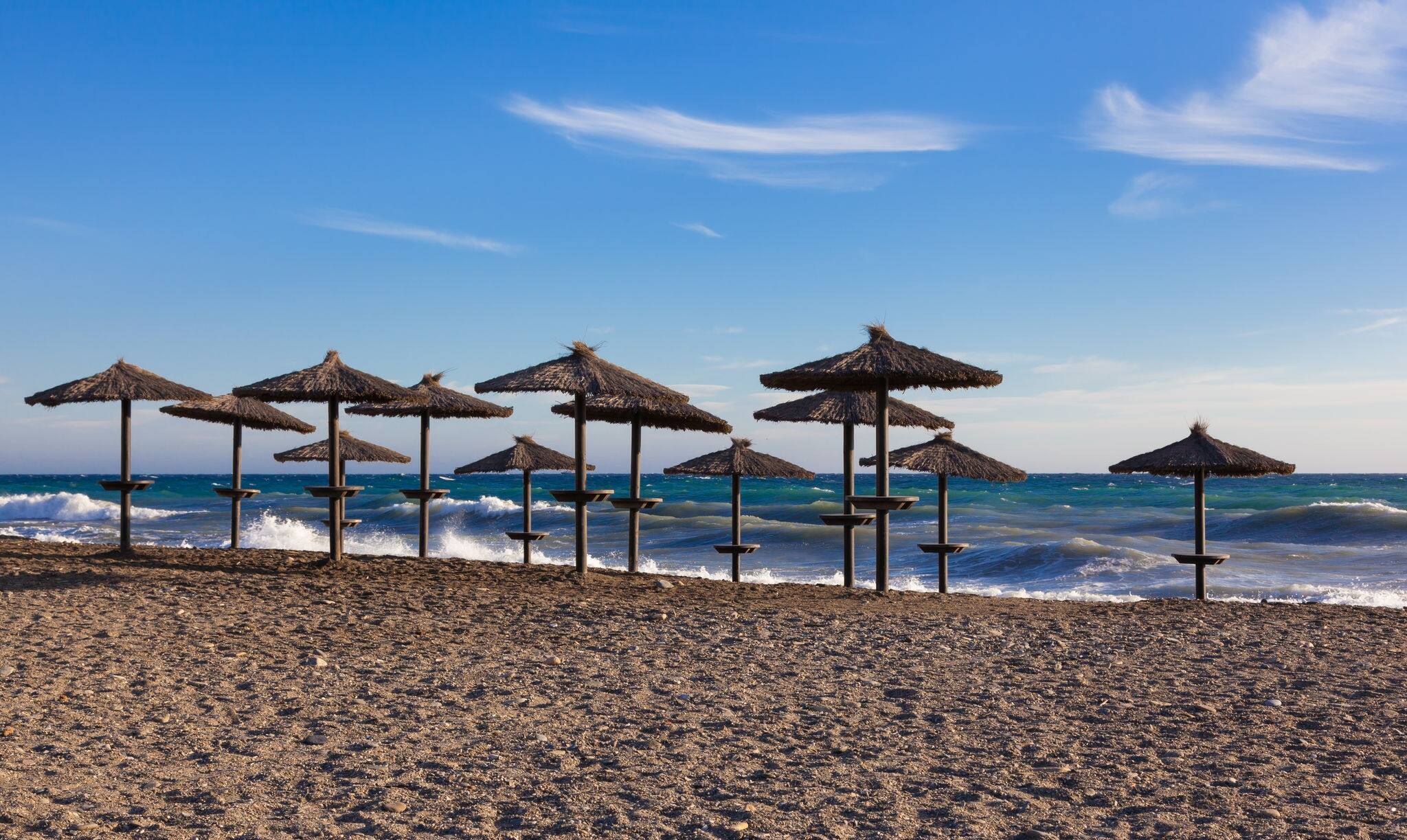 Beach parasols on beach in  Motril, Costa del Sol, Andalucia, Spain