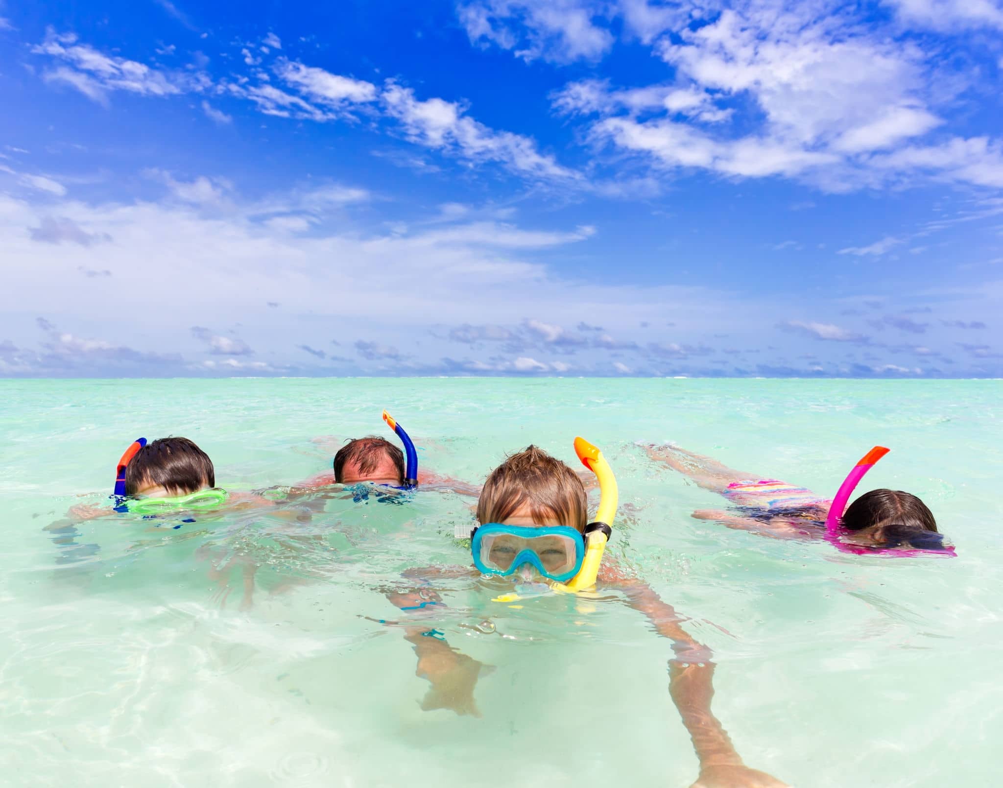 	A family snorkeling in the ocean.