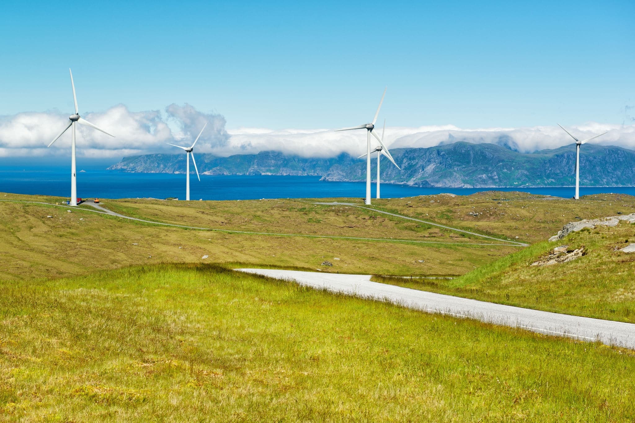 Windmills near the sea producing clean energy at Maloy island, Norway