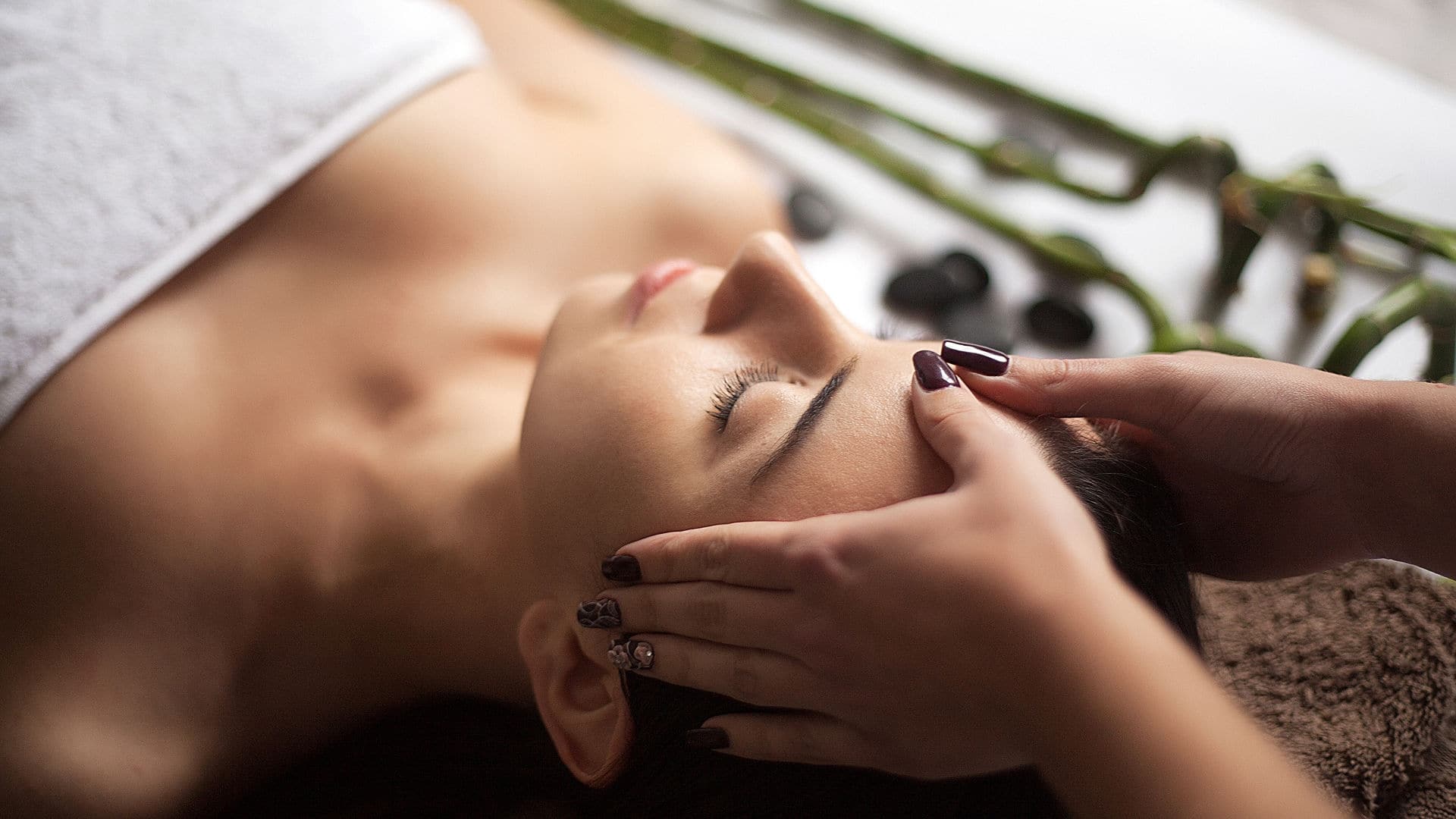 Face Massage. Close-up of a Young Woman Getting Spa Treatment.