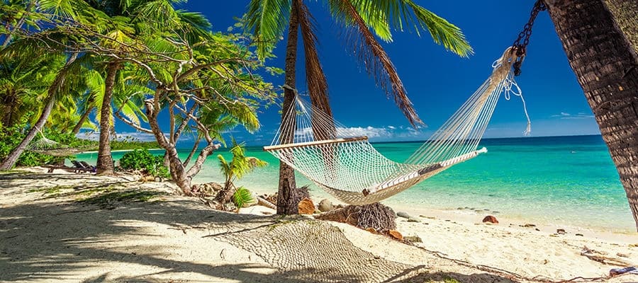 Empty hammock on beach shore.