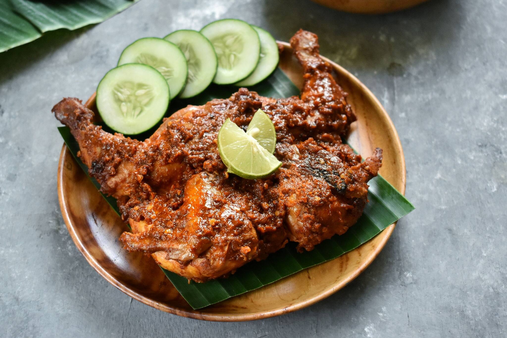 Ayam Taliwang is Lombok's special food is young smoked chicken, spiced and then burned.  the presentation is complete with chili or plecing water spinach