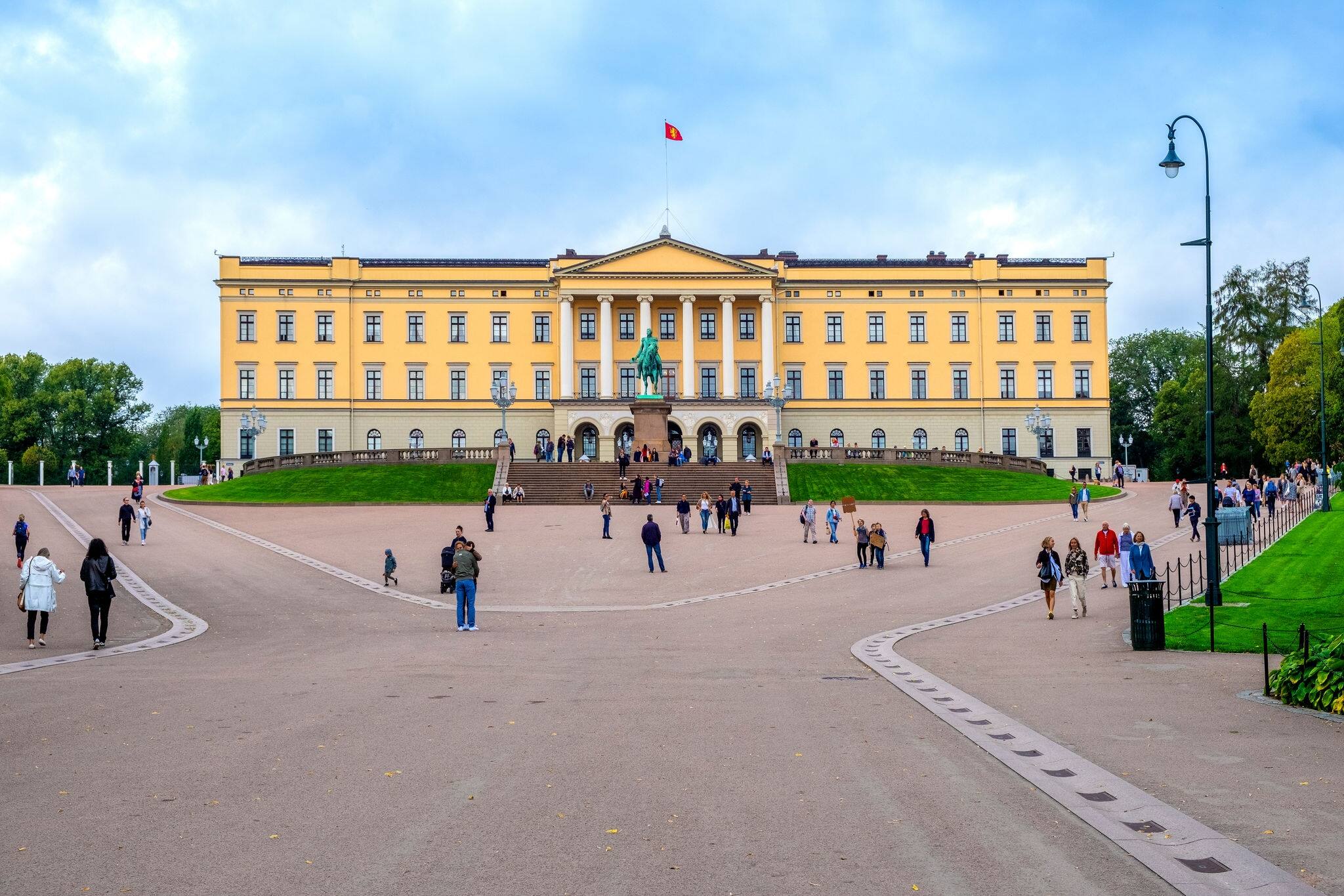 Oslo, Ostlandet / Norway - 2019/08/30: Facade of Oslo Royal Palace - Slottet - on the Bellevuehoyden hill seen from Slottsplassen square in historic city center