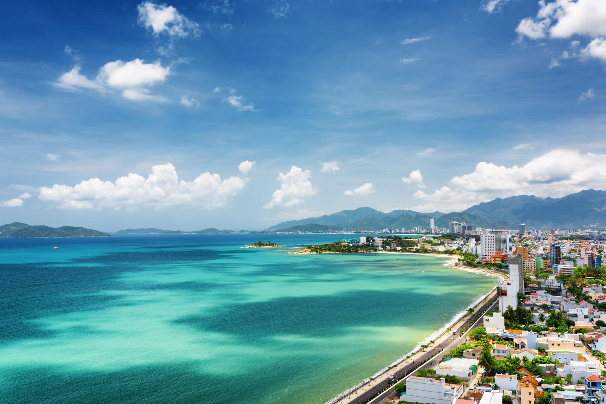 Beautiful view on Nha Trang and Nha Trang Bay of South China Sea with magic colors of water on blue sky background in Khanh Hoa province, Vietnam. Nha Trang is a popular tourist destination of Asia.
