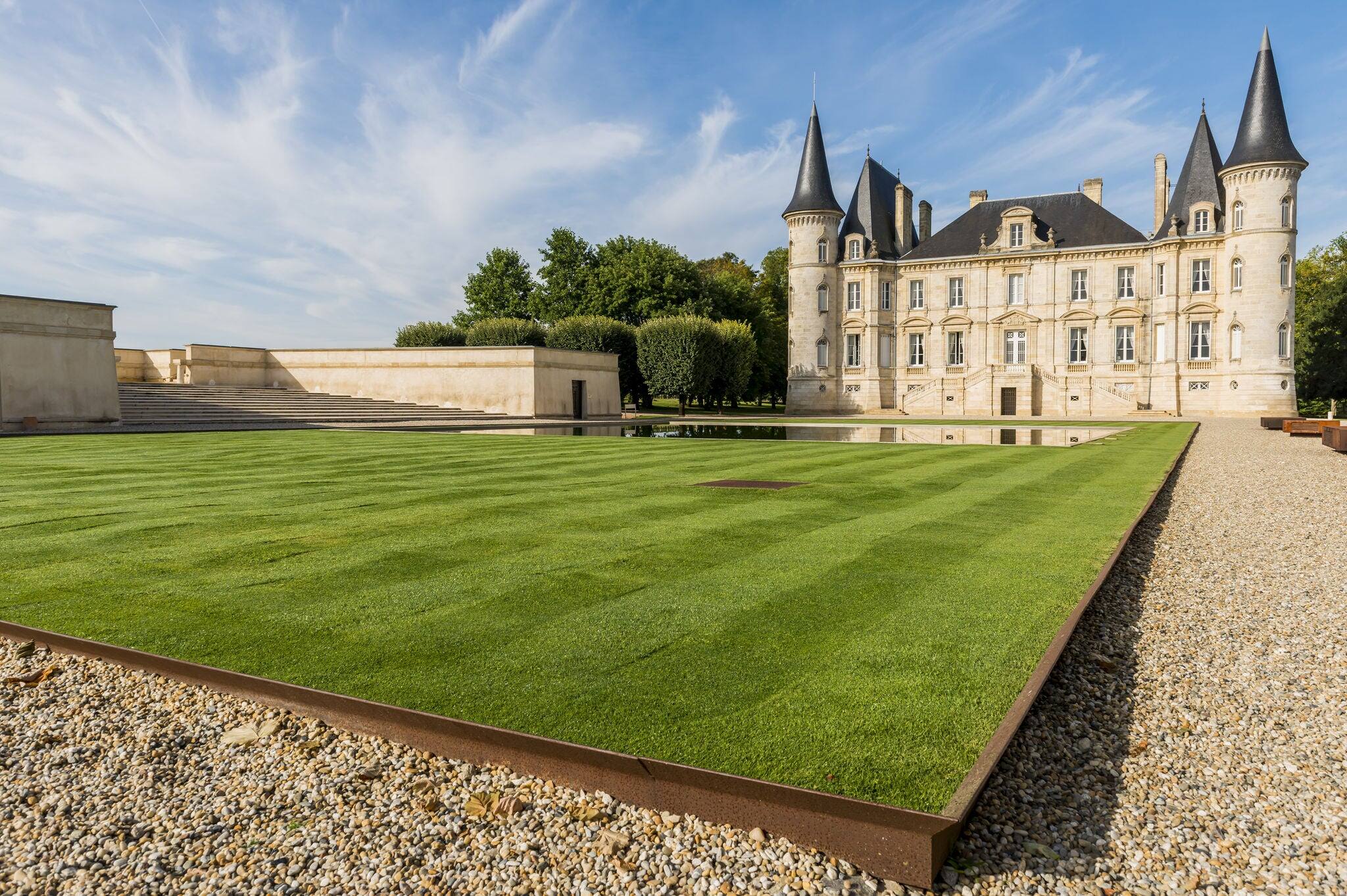 Chateau Pichon-Longueville with towers, garden and great green lawn in the city of Pauillac in Medoc in France.